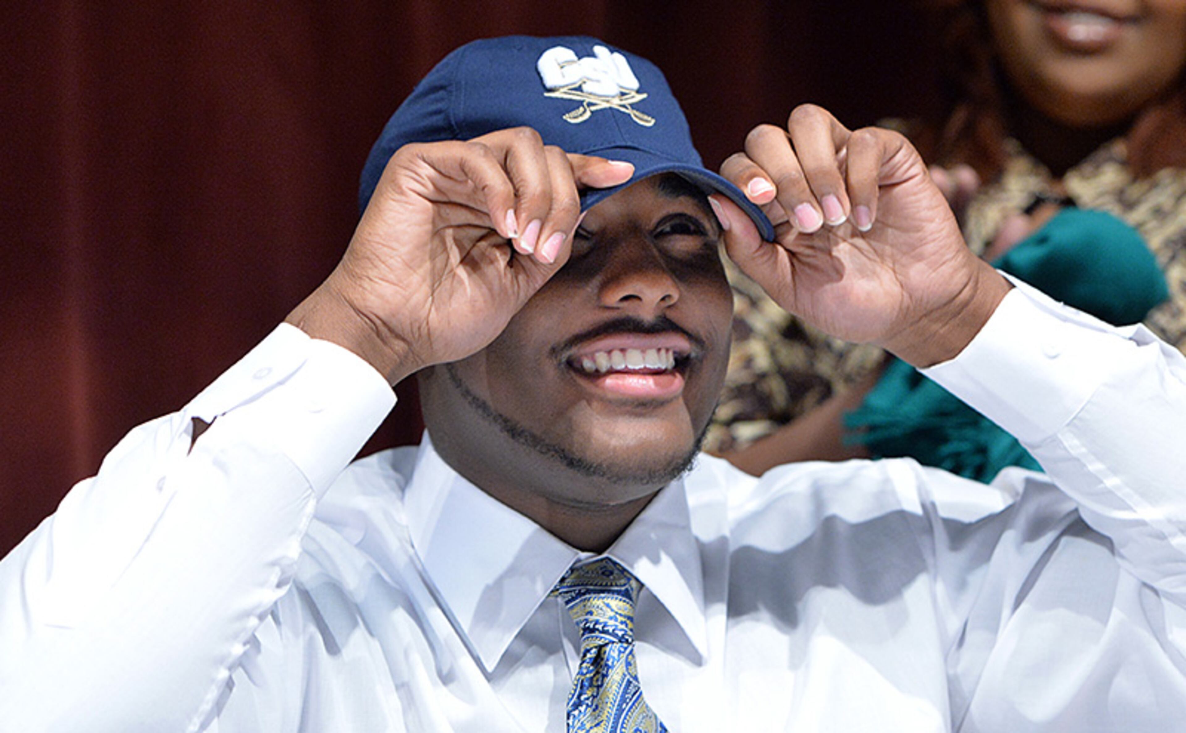 Ramel Hambrick-Crawford picks Charleston Southern putting on his hat during signing day at Tucker High School.
