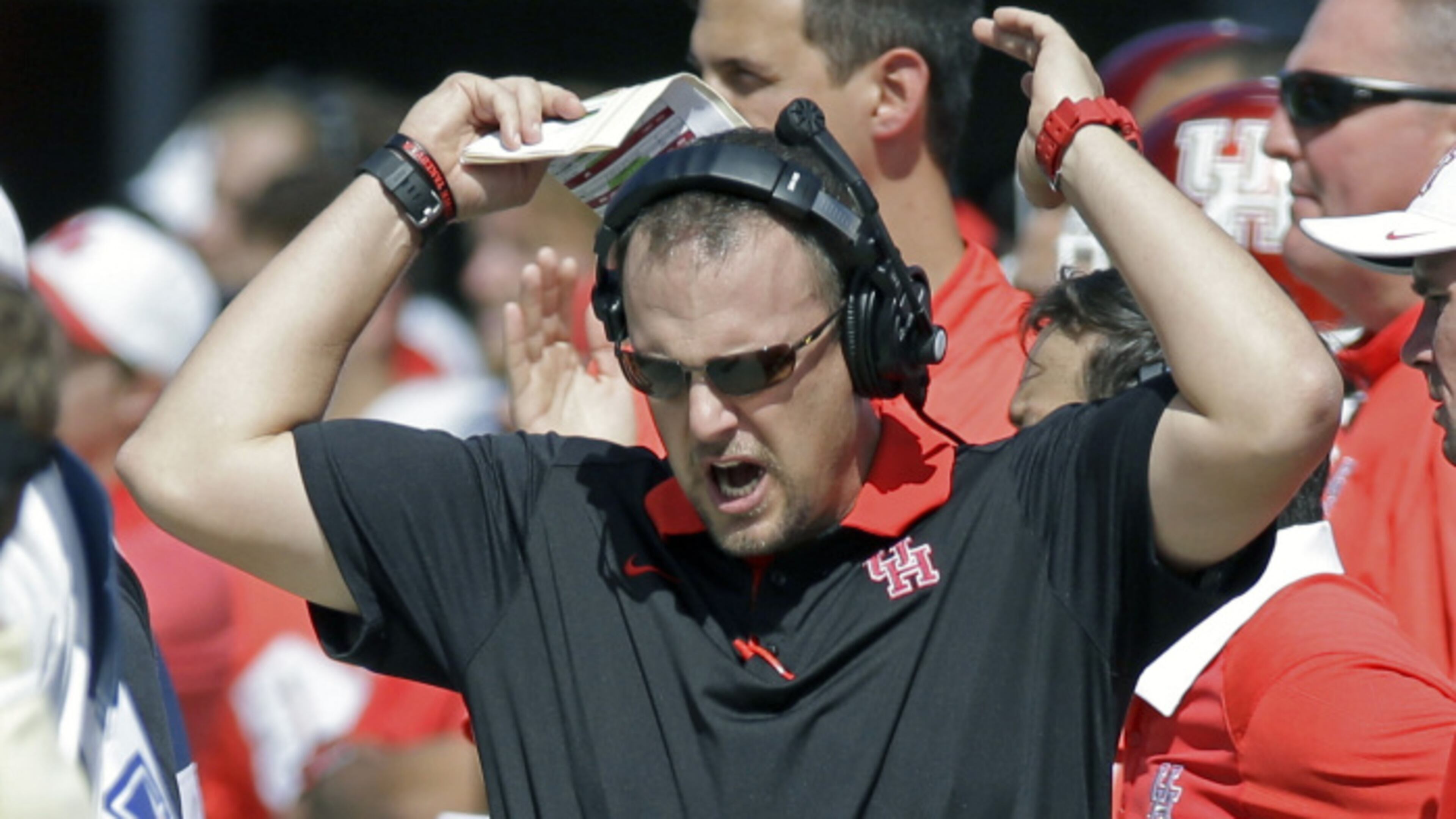 Houston head coach Tom Herman waves his arms as he walks the sidelines during the first half of an NCAA college football game against Central Florida, Saturday, Oct. 24, 2015, in Orlando, Fla. (AP Photo/John Raoux)