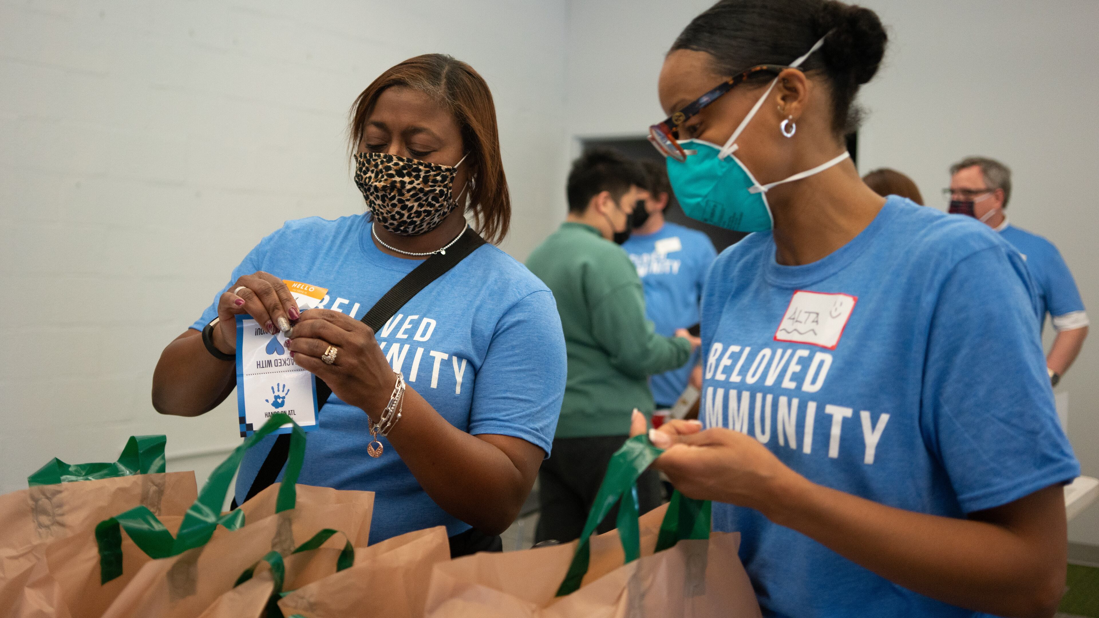 TowerPoint volunteers Gerri Moore (l) and Alta Urtate assembled meal bags during a Hands On Atlanta effort on the MLK holiday.