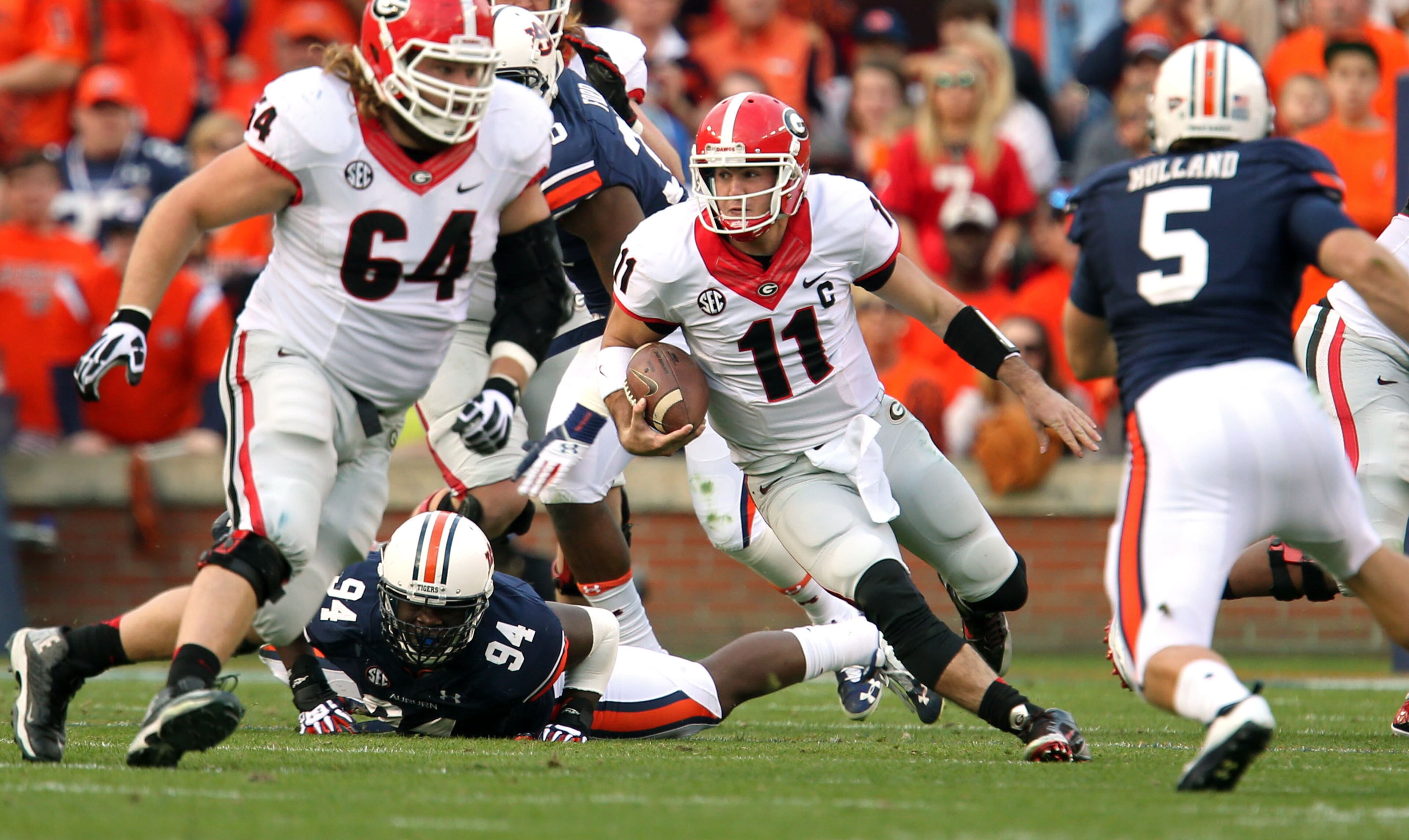 Georgia Bulldogs quarterback Aaron Murray (11) runs for a first down past the defense of Auburn Tigers defensive end Nosa Eguae (94) in the first half of their game at Jordan-Hare Stadium Saturday afternoon in Auburn, Al., November 16, 2013.
