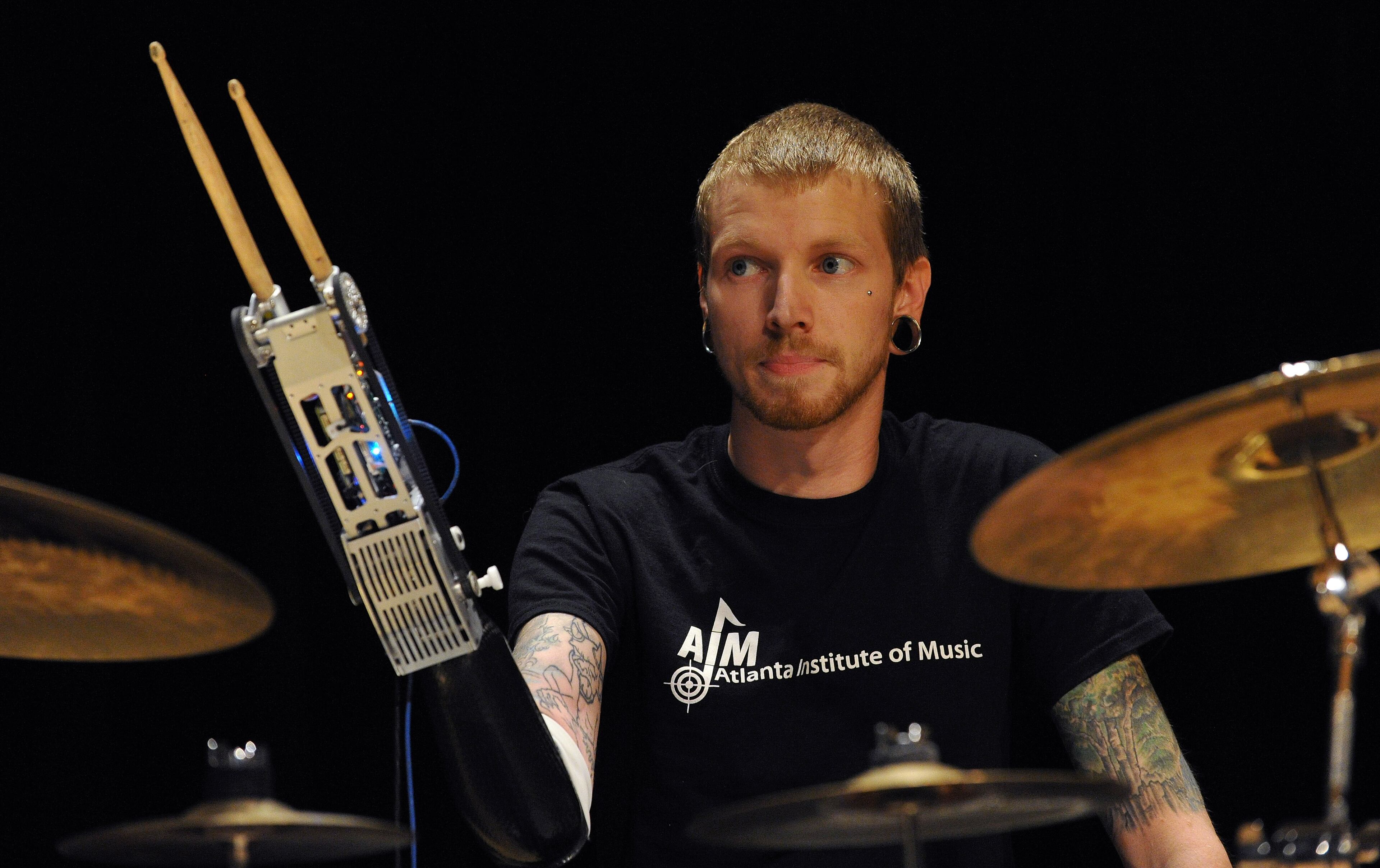 Aspiring musician Jason Barnes, a drummer who lost his right hand in an accident, uses his myo-electrically controlled robot arm developed by Georgia Tech engineers during a Kennesaw State University concert on Saturday March 21, 2014 in Kennesaw, Ga. David Tulis / AJC Special