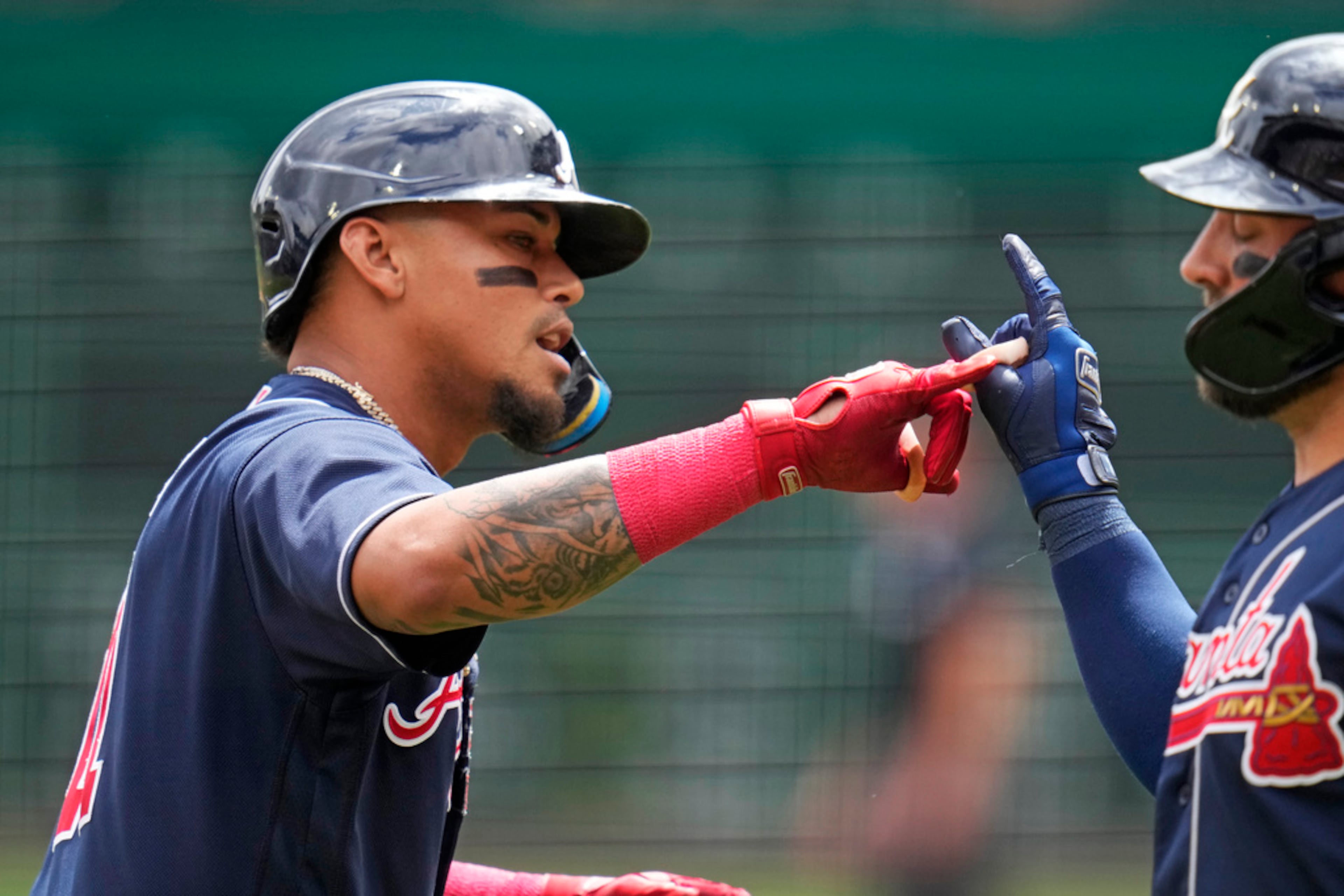 Atlanta Braves' Orlando Arcia, left, celebrates with Kevin Pillar as he returns to the dugout after hitting a solo home run off Pittsburgh Pirates starting pitcher Bailey Falter during the second inning of a baseball game in Pittsburgh, Thursday, Aug. 10, 2023. (AP Photo/Gene J. Puskar)