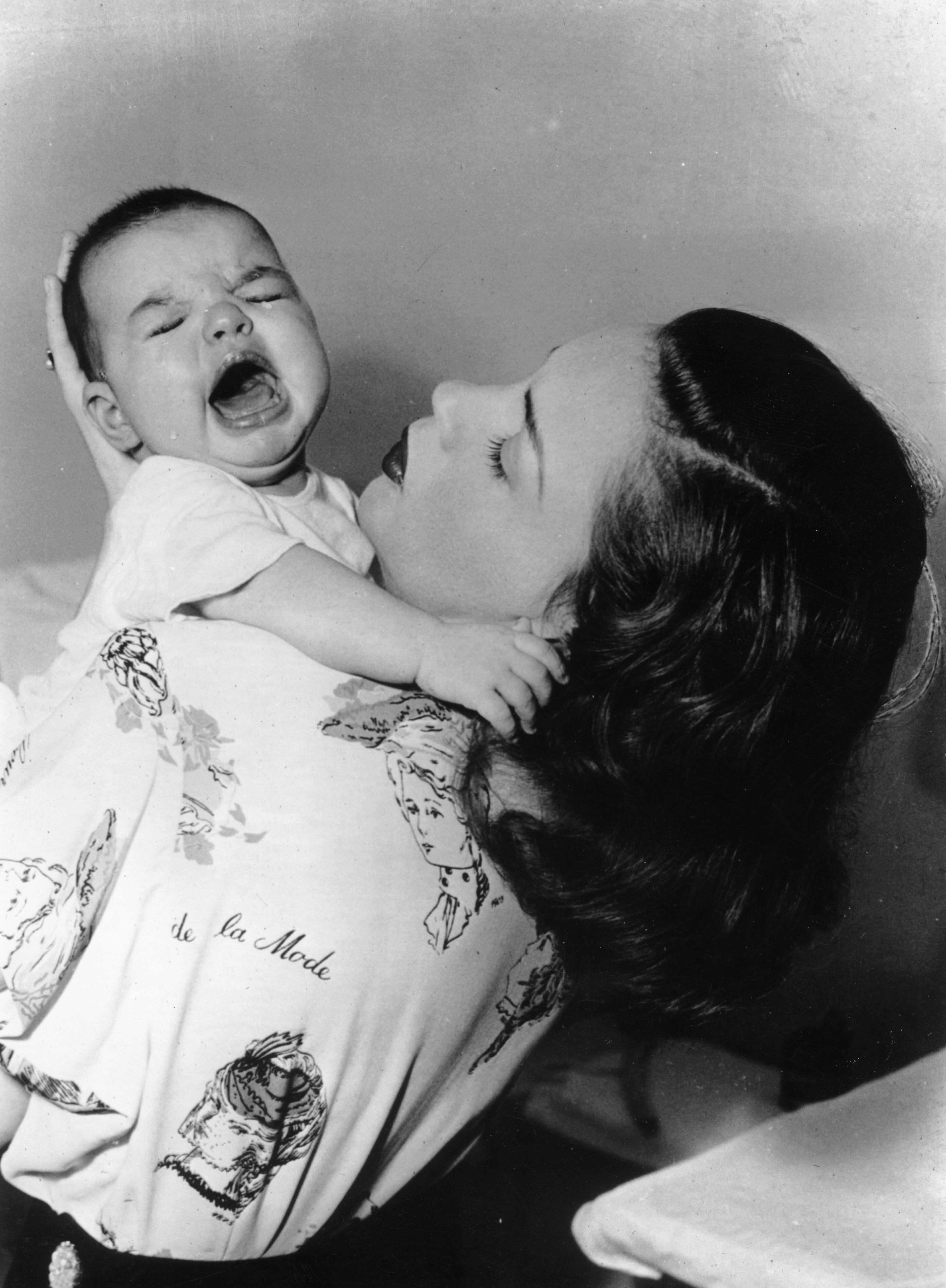 American actress Judy Garland (1928 - 1969) holding her and film director Vincente Minnelii's daughter Liza, who later became famous in her own right as an actress and singer. (Photo by Keystone/Getty Images)