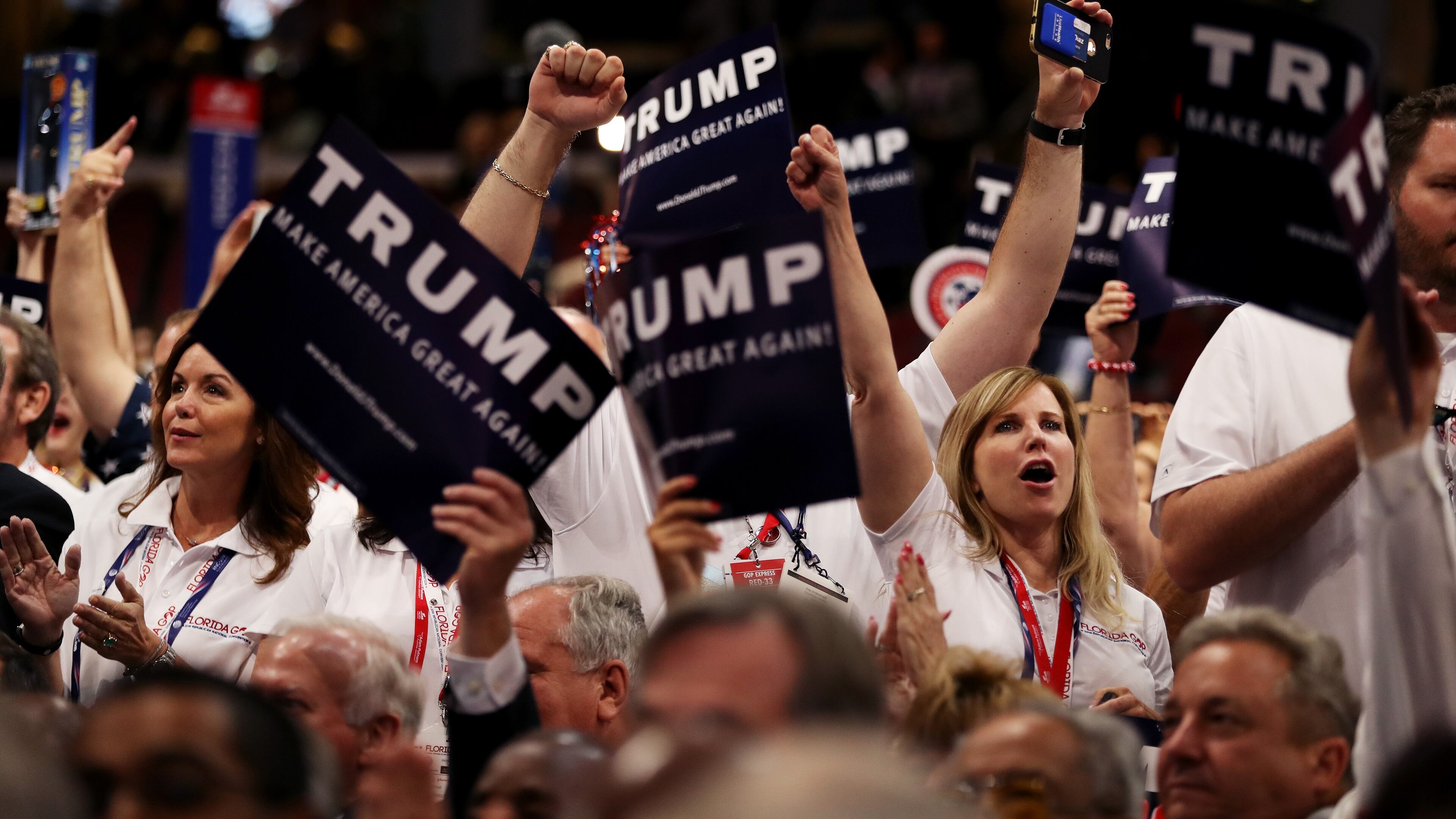 CLEVELAND, OH - JULY 19: Delegates hold signs in support of presumptive Republican presidential candidate Donald Trump during roll call on the second day of the Republican National Convention on July 19, 2016 at the Quicken Loans Arena in Cleveland, Ohio. An estimated 50,000 people are expected in Cleveland, including hundreds of protesters and members of the media. The four-day Republican National Convention kicked off on July 18. (Photo by Joe Raedle/Getty Images)