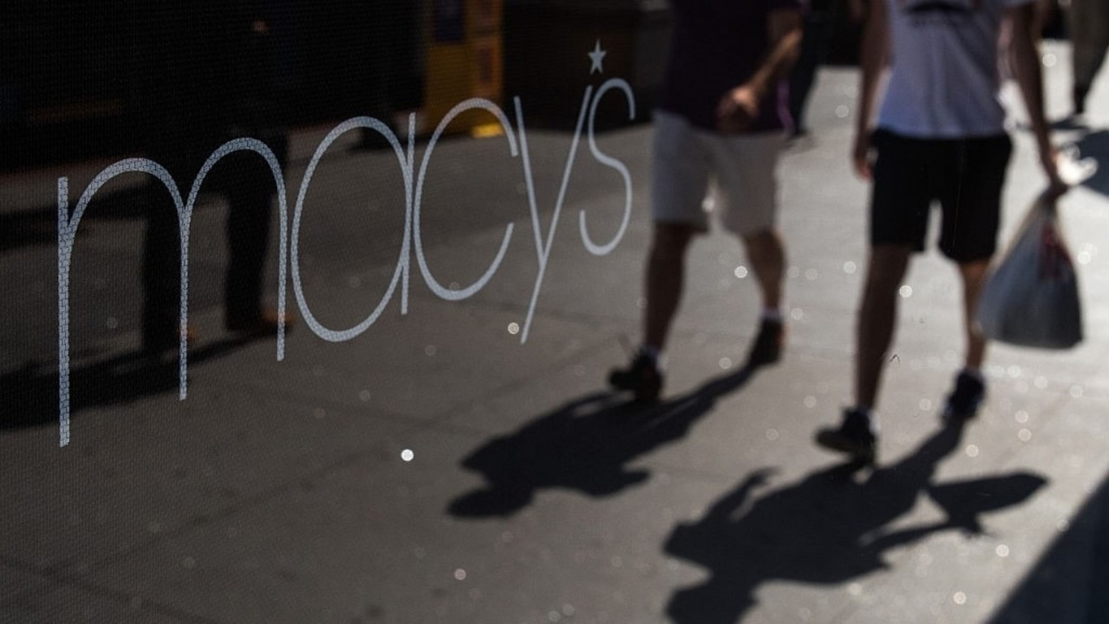 NEW YORK, NY - AUGUST 11: People are reflected in a store window as they walk past Macy's flagship store in Herald Square, August 11, 2016 in New York City.
