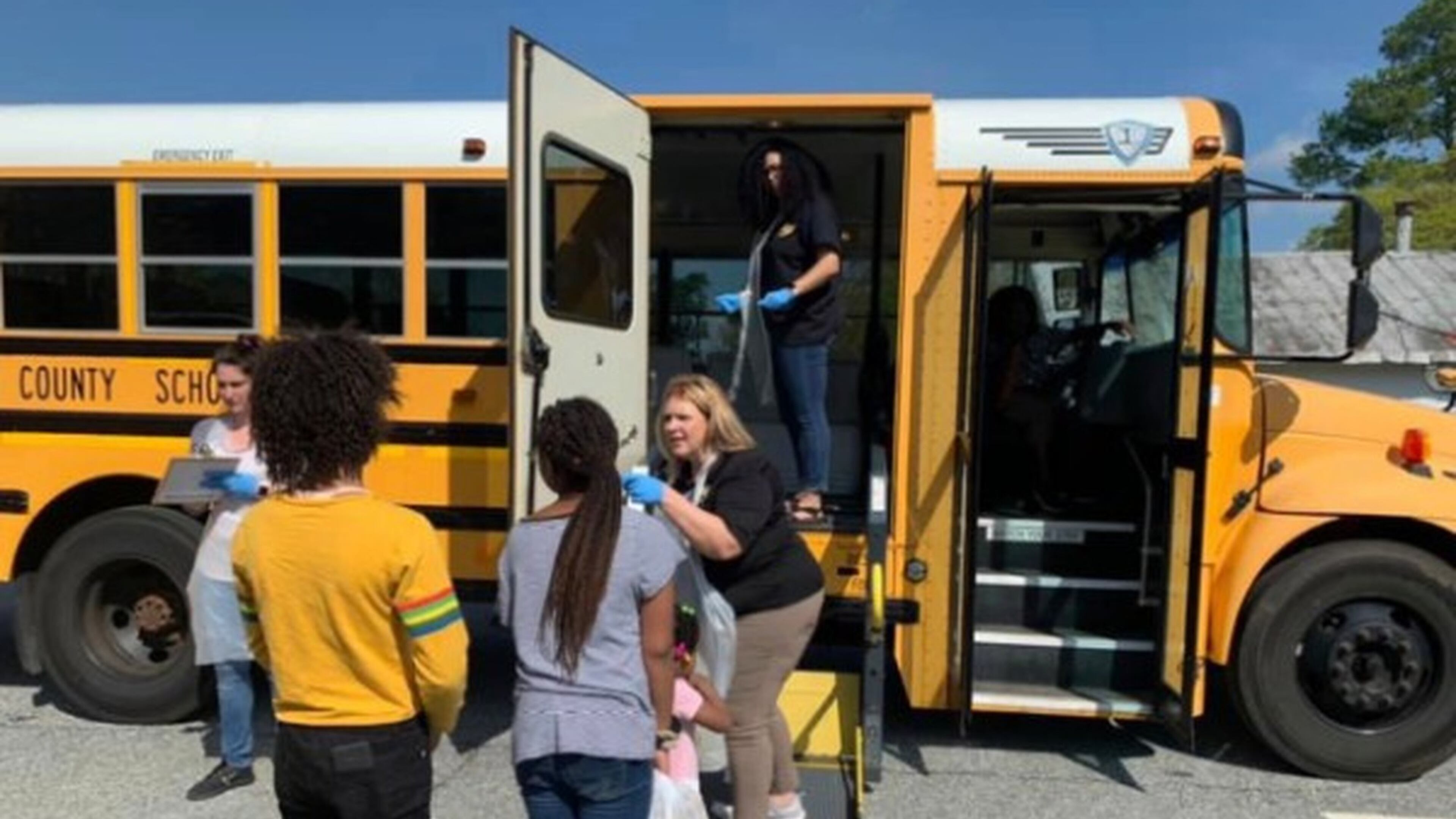Chattahoochee County school district school counselor, superintendent and school food staff are at a community stop delivering meals. Georgia school districts could use federal government stimulus funds to provide hazard pay for staff delivering meals to students during the coronavirus. CONTRIBUTED