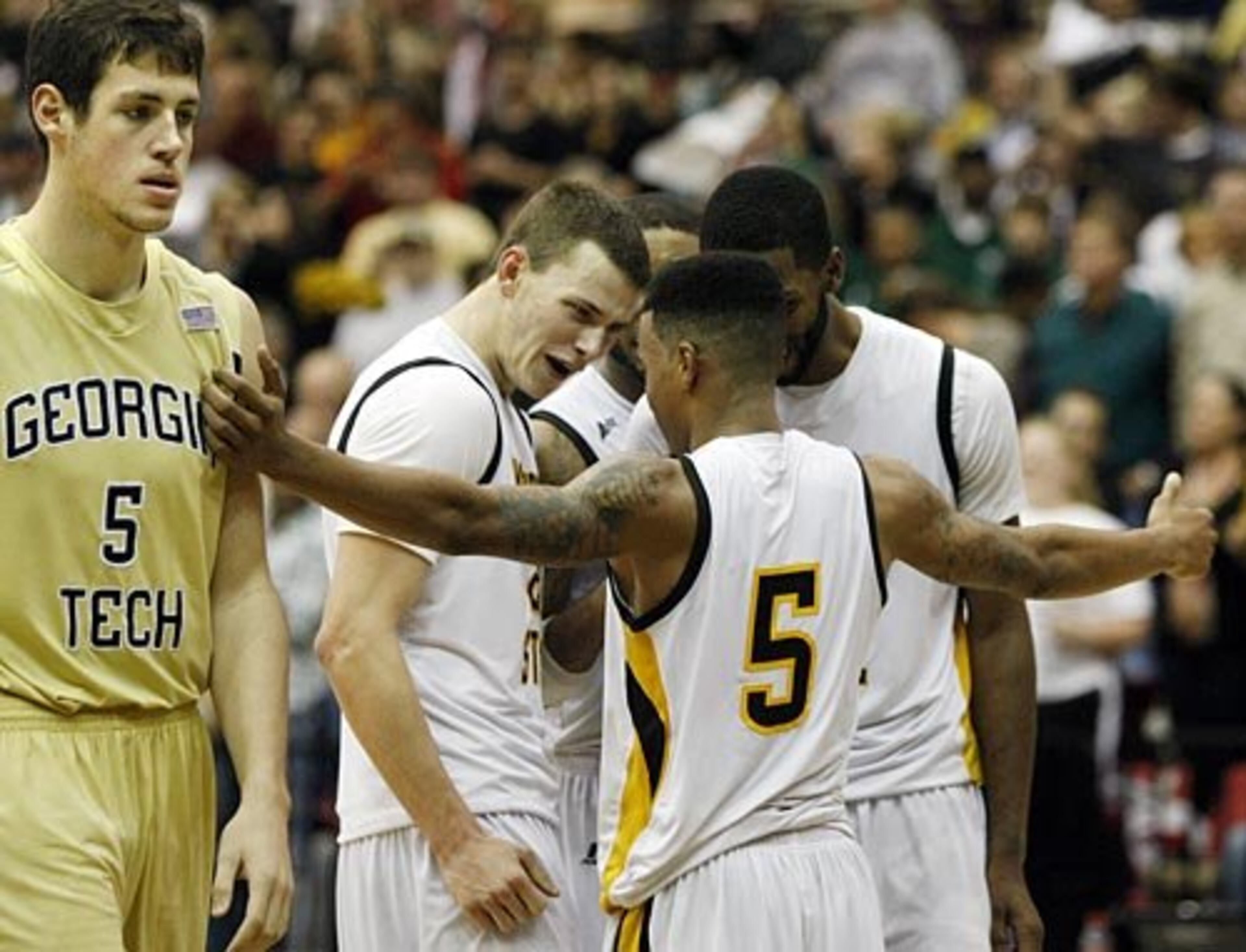 The Jackets' Daniel Miller walks away as the celebration begins for the Owls.