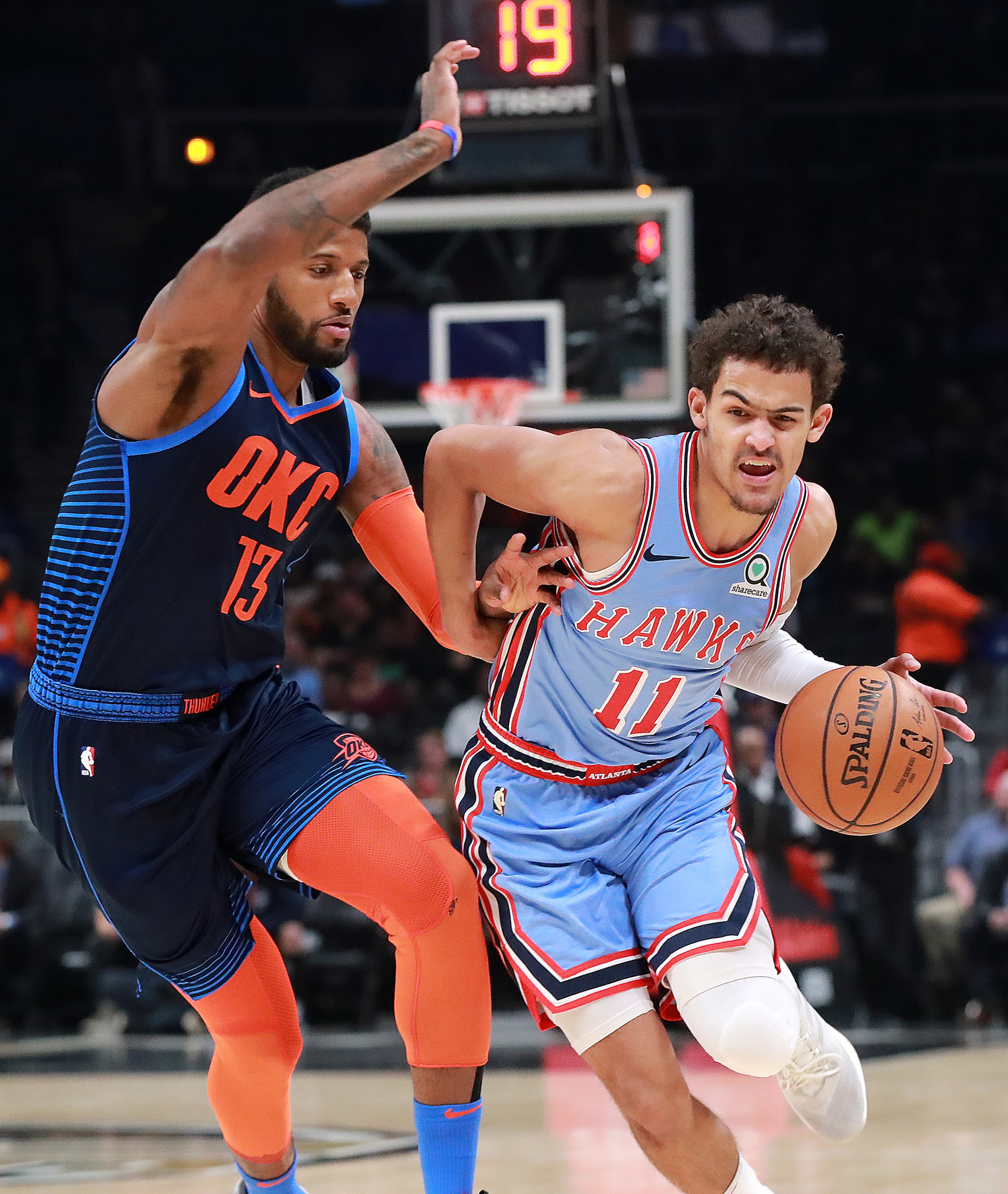 Jan. 15, 2019 Atlanta: Atlanta Hawks guard Trae Young drives past Oklahoma City Thunder Paul George during the first half in a NBA basketball game on Tuesday, Jan. 15, 2019, at State Farm Arena in Atlanta. The Hawks beat the Thunder 142-126. Curtis Compton/ccompton@ajc.com