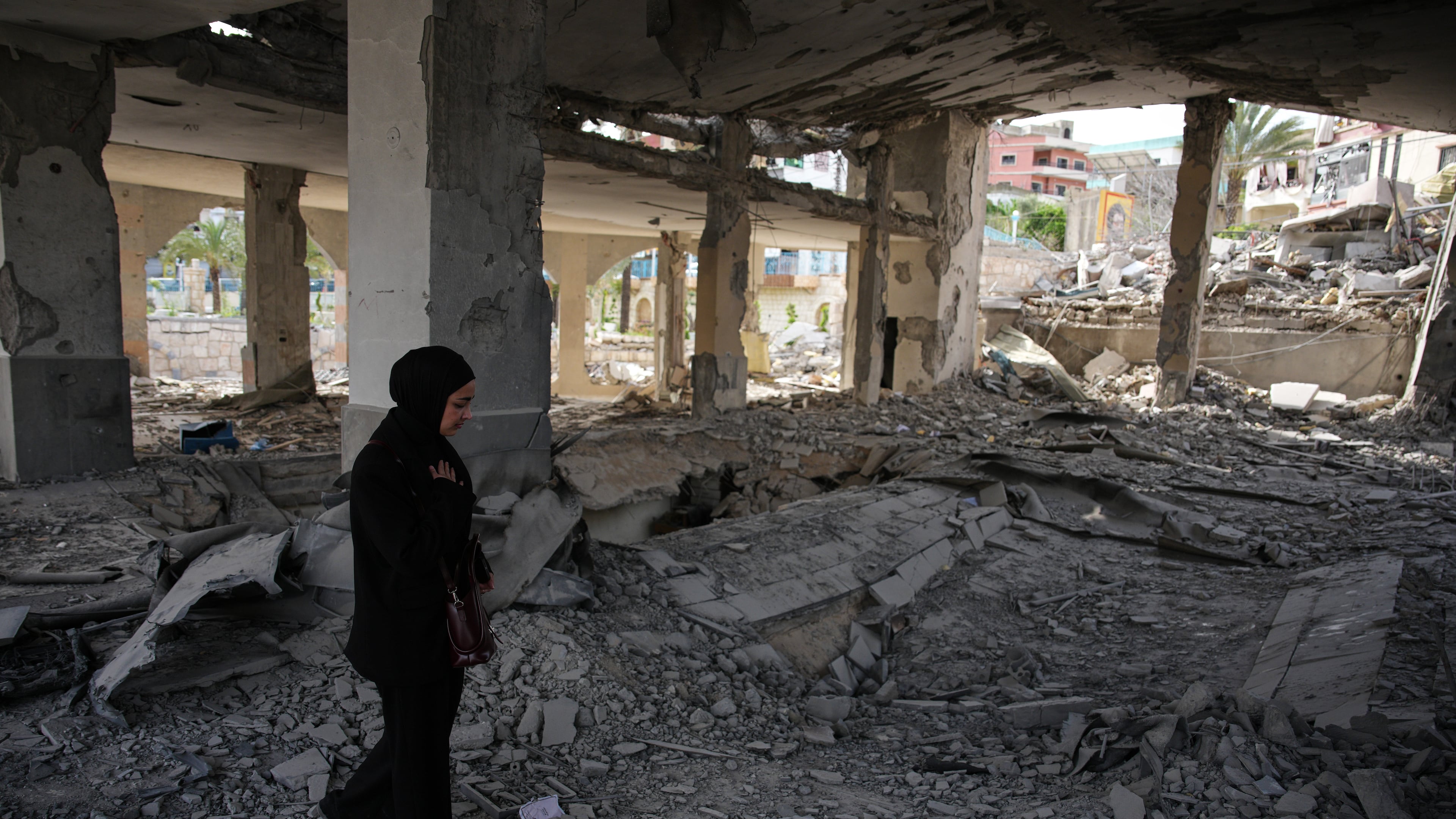 A local resident walks among debris inside a mosque destroyed in an Israeli airstrike in Jibchit, southern Lebanon, Friday, April 17, 2026, following a ceasefire between Israel and Hezbollah. (AP Photo/Hassan Ammar)
