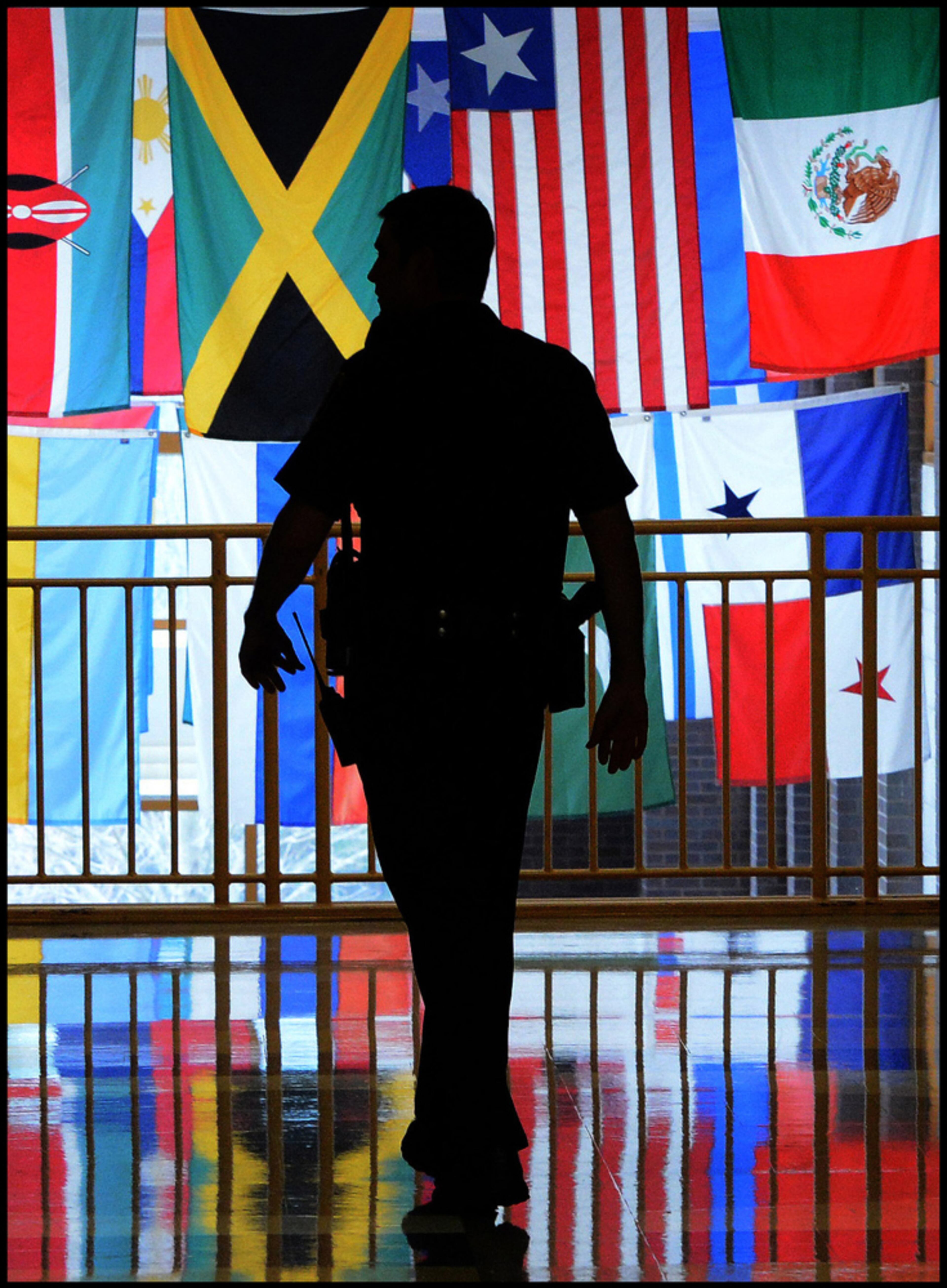 010913 Marietta: For a story on school security I decided to make Marietta High School Resource officer Adam Gravitt a silhouette as he walked down a hall at Marietta High School on Tuesday, January 9, 2013. Camera Nikon D4, Lens 70 to 200mm 2.8, ISO 5000, Aperture f8, Shutter speed 250. JOHNNY CRAWFORD / JCRAWFORD@AJC.COM