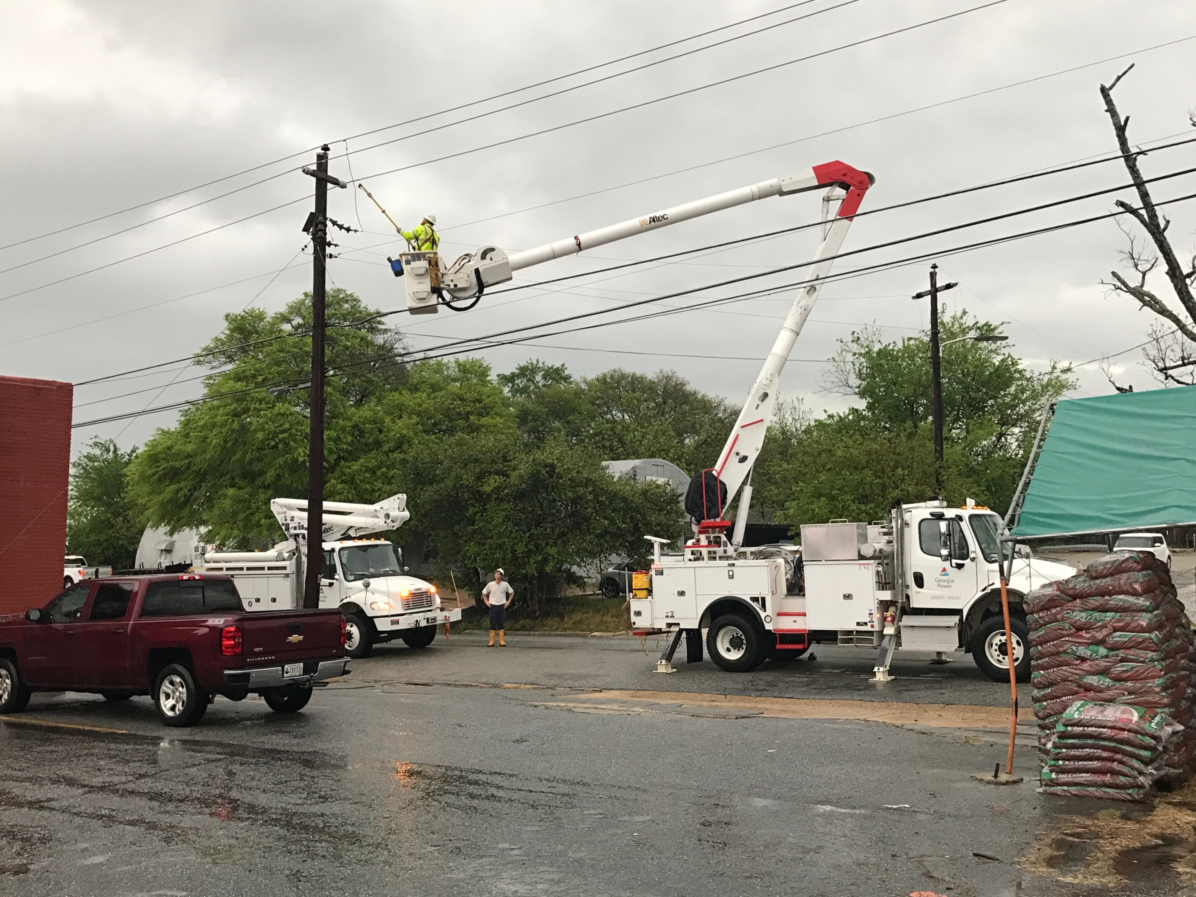 A Georgia Power employee addresses a power line that snapped due to heavy wind and rains that swept through Americus early in the afternoon of April 5, 2017.