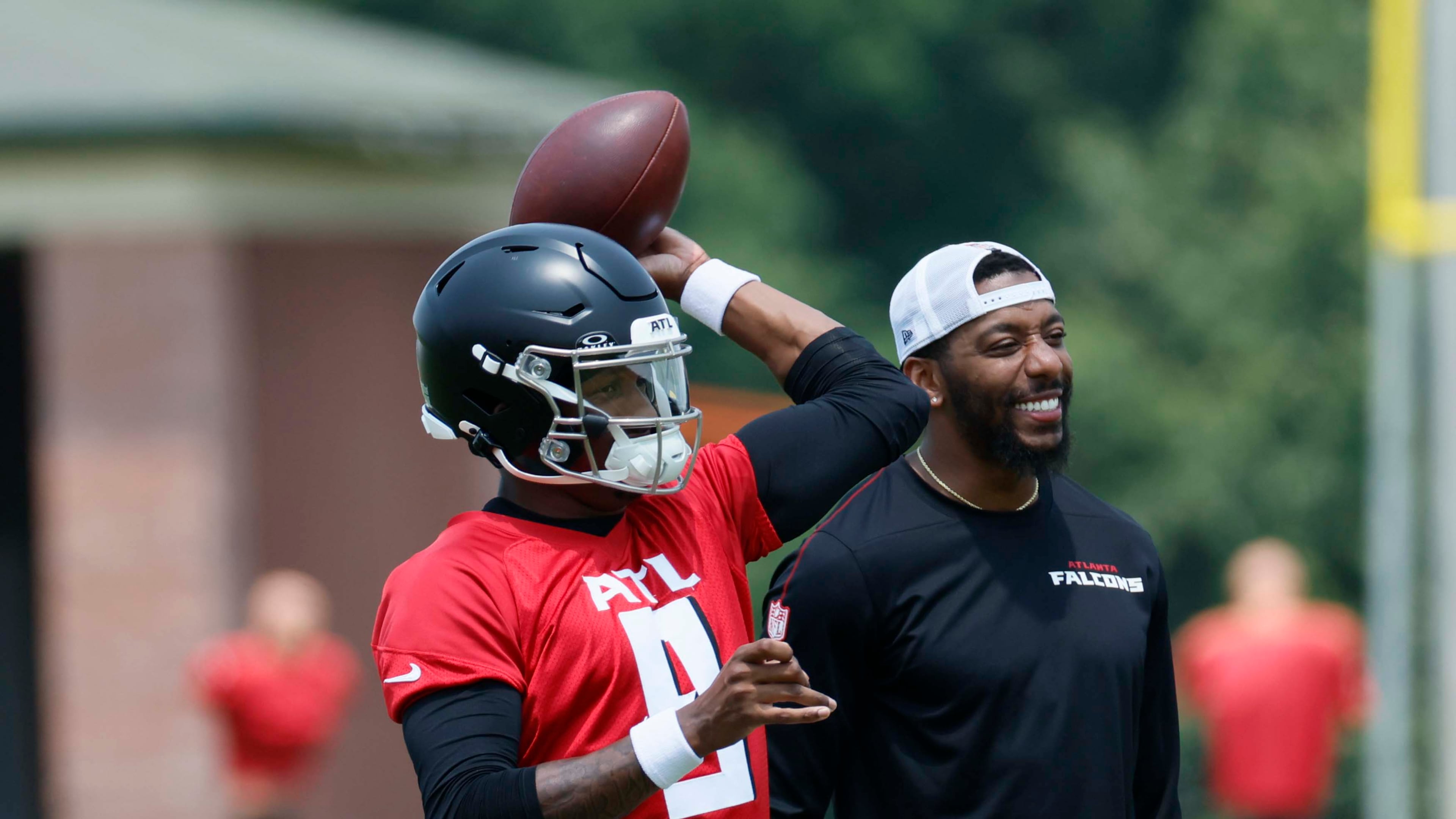 Atlanta Falcons quarterback Michael Penix Jr (left) attempts a pass alongside quarterbacks coach D.J. Williams (right) at the Atlanta Falcons Training Facility, Monday, June 2, 2025, in Flowery Branch, Ga. (Miguel Martinez/AJC)