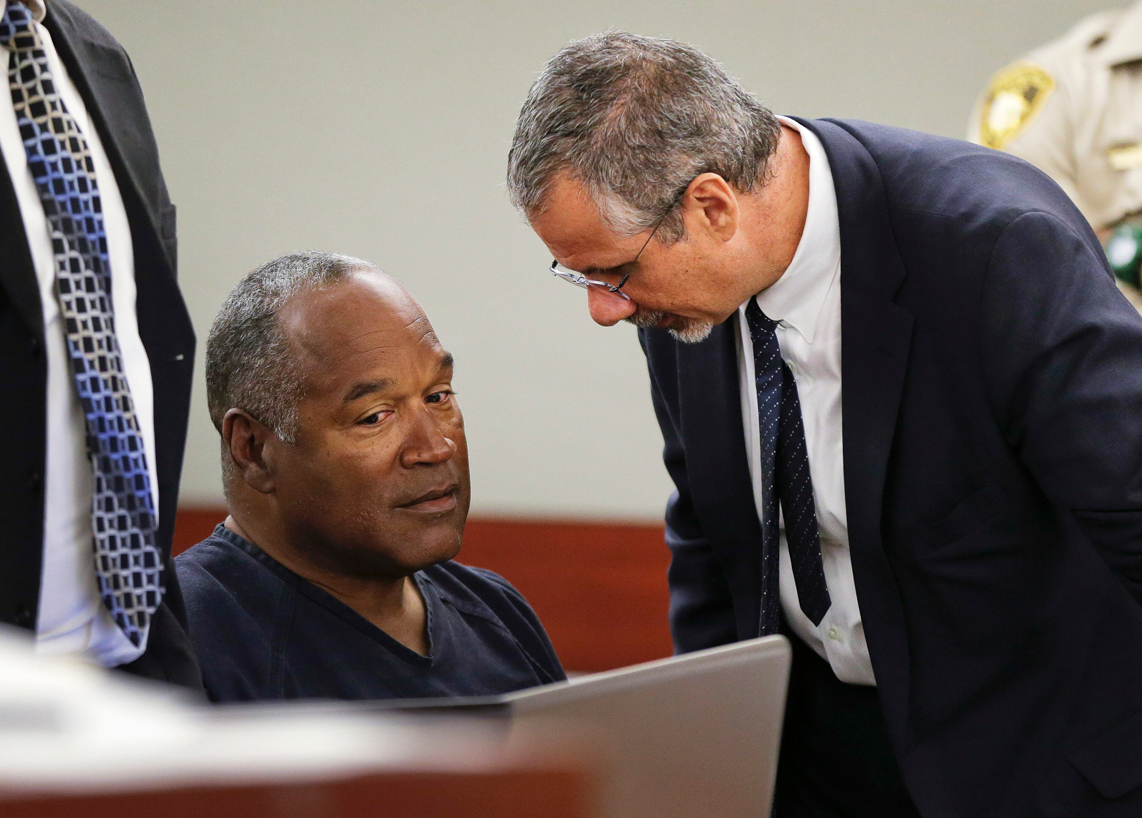 LAS VEGAS, NV - MAY 13: O.J. Simpson (L) talks with his attorney Ozzie Fumo during his evidentiary hearing in Clark County District Court, May 13, 2013 in Las Vegas, Nevada. Simpson, who is currently serving a nine to 33-year sentence in state prison as a result of his October 2008 conviction for armed robbery and kidnapping charges, is using a writ of habeas corpus, to seek a new trial, claiming he had such bad representation that his conviction should be reversed. (Photo by Julie Jacobson-Pool/Getty Images)
