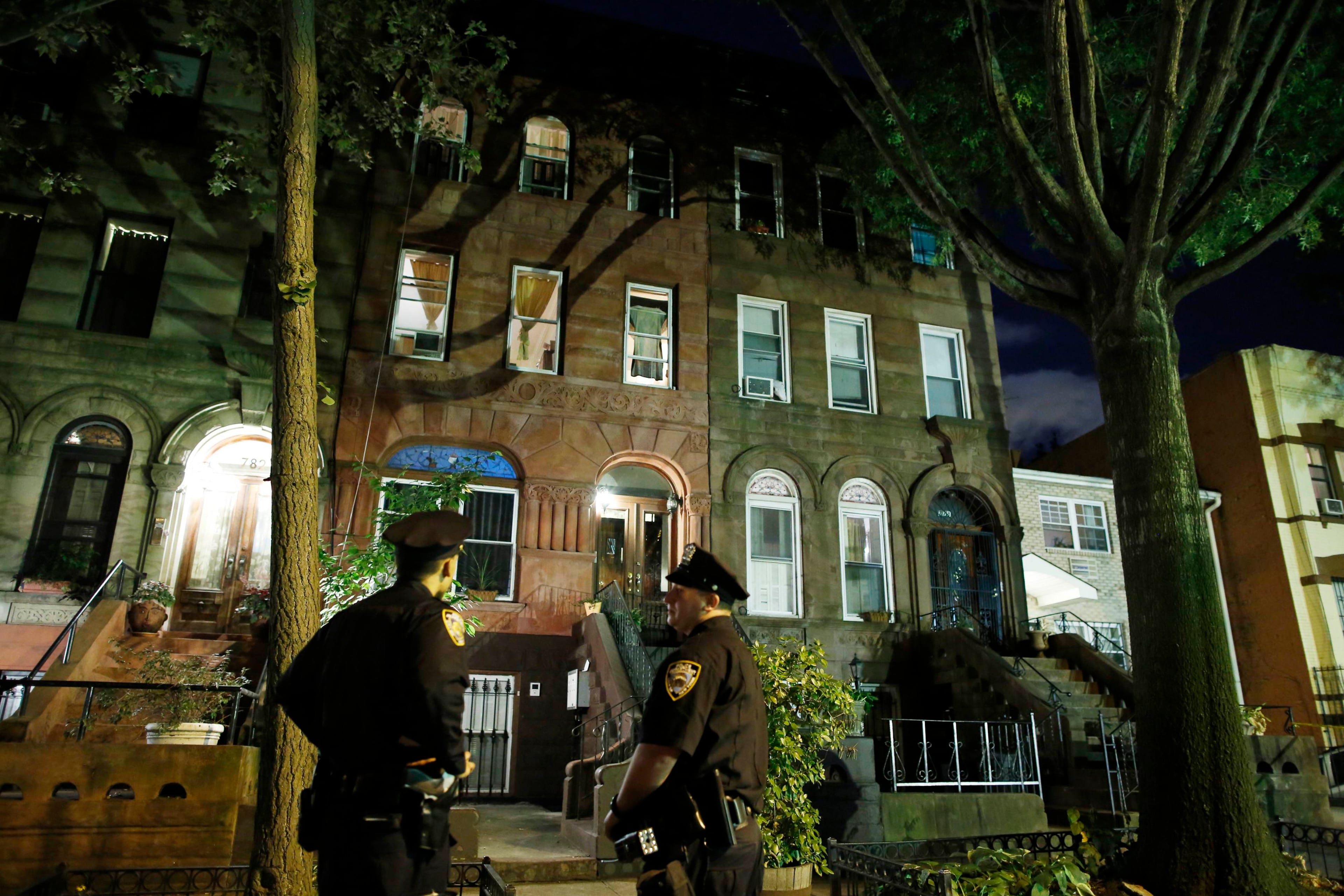 Police stand guard outside the Brooklyn residence of Cathleen Alexis, mother of suspected Washington Navy Yard shooter Aaron Alexis, in New York September 16, 2013. The U.S. military veteran opened fire at the Washington Navy Yard on Monday in a burst of violence that killed 13 people, including the gunman, and set off waves of panic at the military installation just miles from the White House and U.S. Capitol. The FBI identified the suspect as Aaron Alexis, 34, of Fort Worth, Texas, a Navy contractor who had two gun-related brushes with the law. REUTERS/Andrew Kelly