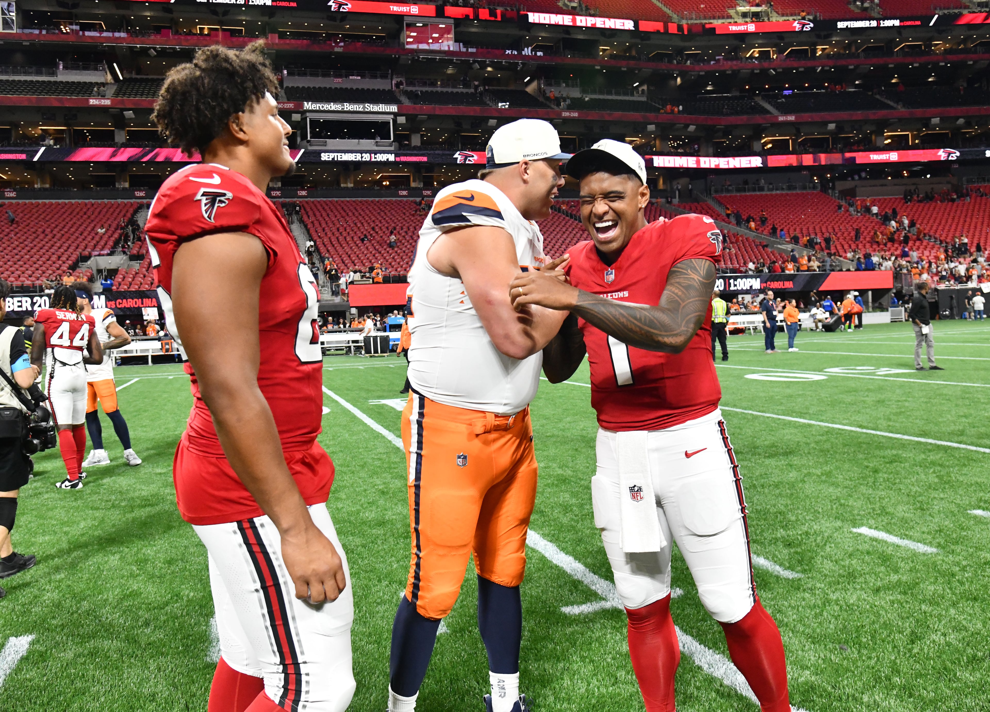 Falcons quarterback Tua Tagovailoa (right) and Broncos offensive tackle Garett Bolles greet each other after their preseason game at Mercedes-Benz Stadium on Friday, Aug. 14, 2026, in Atlanta. (Hyosub Shin/AJC)