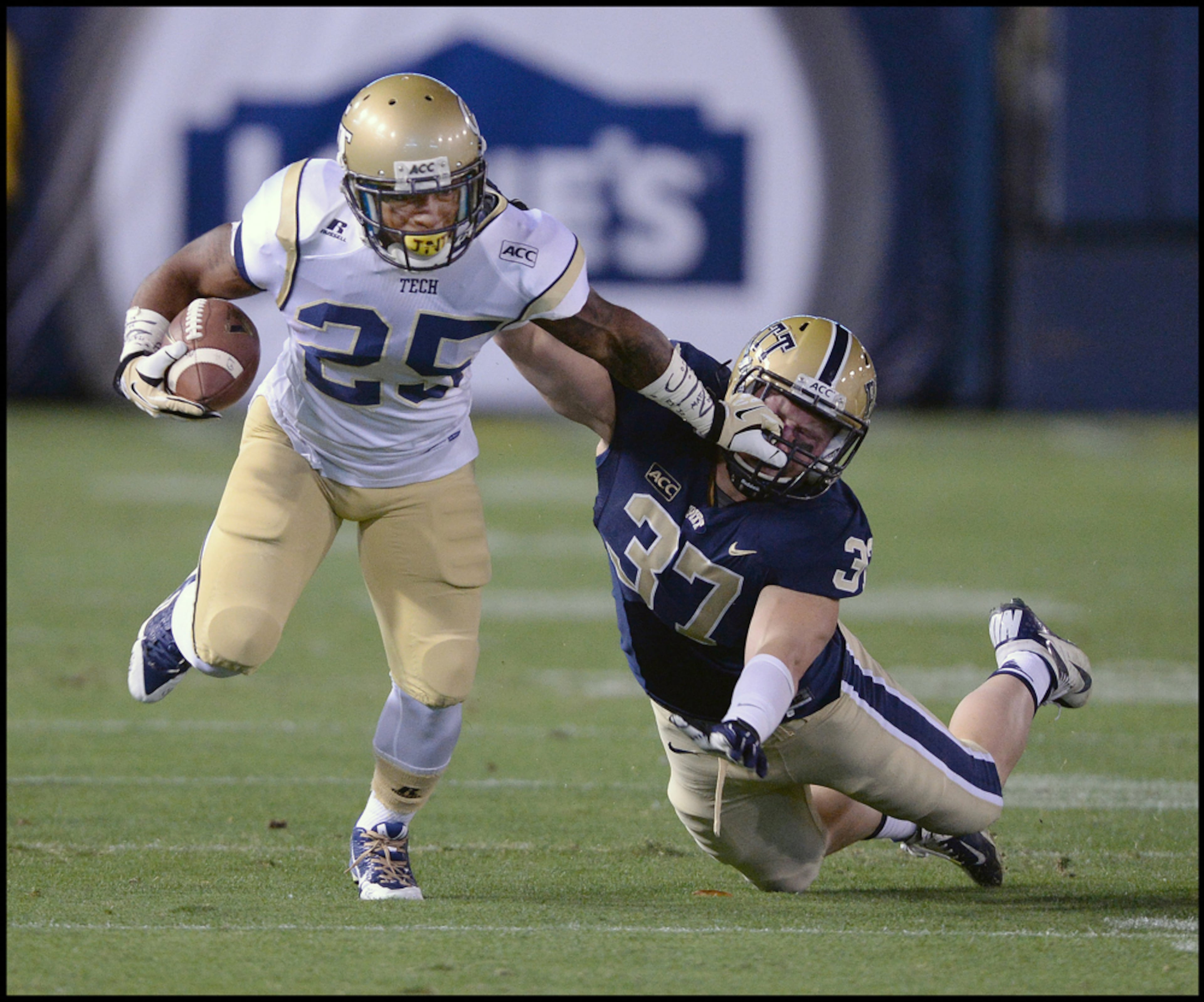 November 2, 2013 - Atlanta: My best stiff arm and face mask photo of 2013. Georgia Tech's Robert Godhigh (25) gives David Durham (37) a stiff arm to the face as he runs for a first down in the first quarter of the Georgia Tech vs Pittsburgh football game on Saturday, November 2, 2013. Georgia Tech won the game. Camera Nikon D4, Lens 500mm f4, ISO 4000, Aperture f4, Shutter speed 1/1250. JOHNNY CRAWFORD / JCRAWFORD@AJC.COM