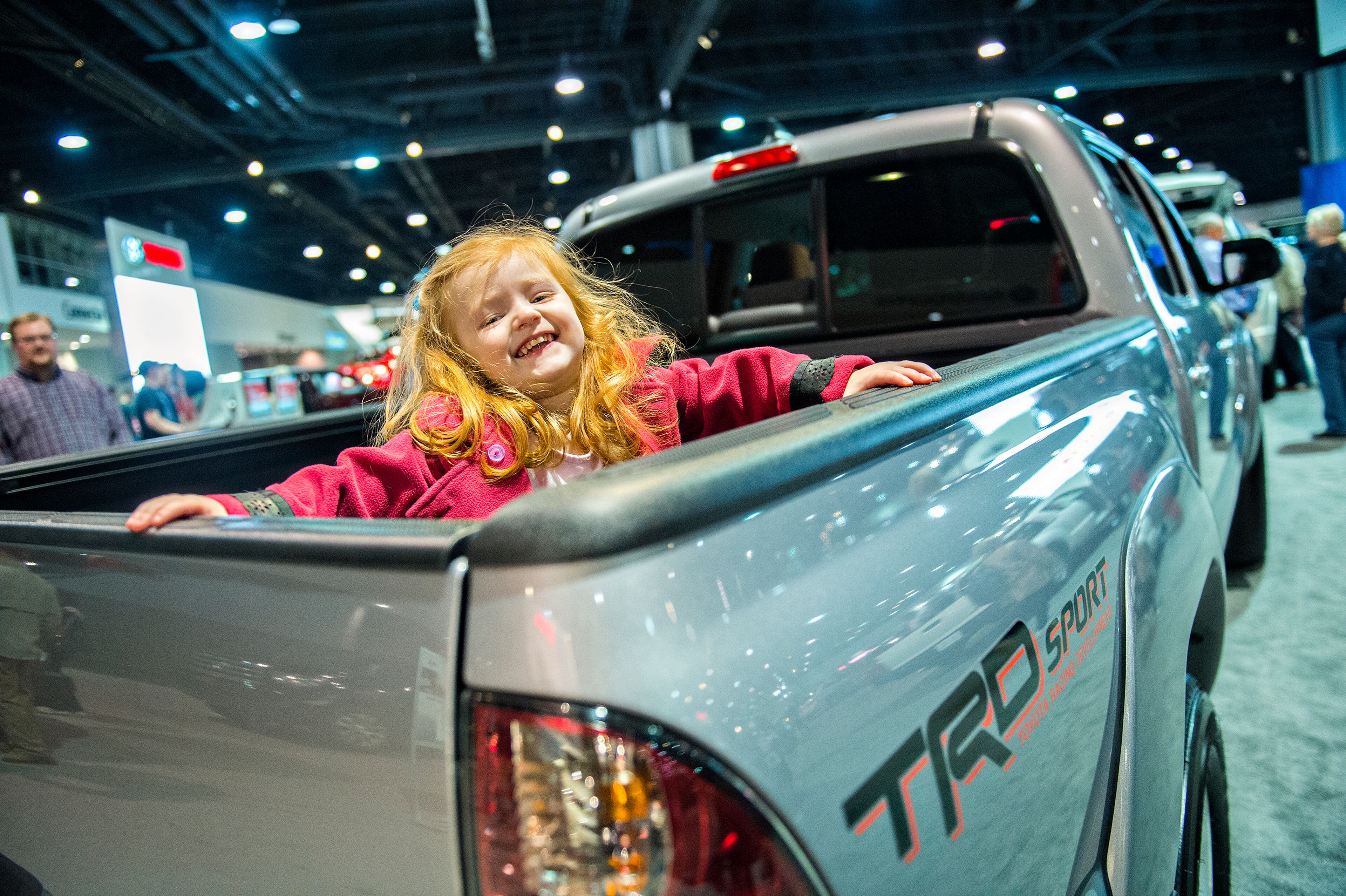 March 29, 2015 Atlanta - Meredith Koues plays in the bed of a Toyota Tacoma during the Atlanta International Auto Show at the Georgia World Congress Center on Sunday, March 29, 2015. The four day show featured automobiles from 29 different manufacturers including Jeep, Chevrolet, Alfa Romeo, Lexus, BMW, Nissan, Volkswagen and more. JONATHAN PHILLIPS / SPECIAL