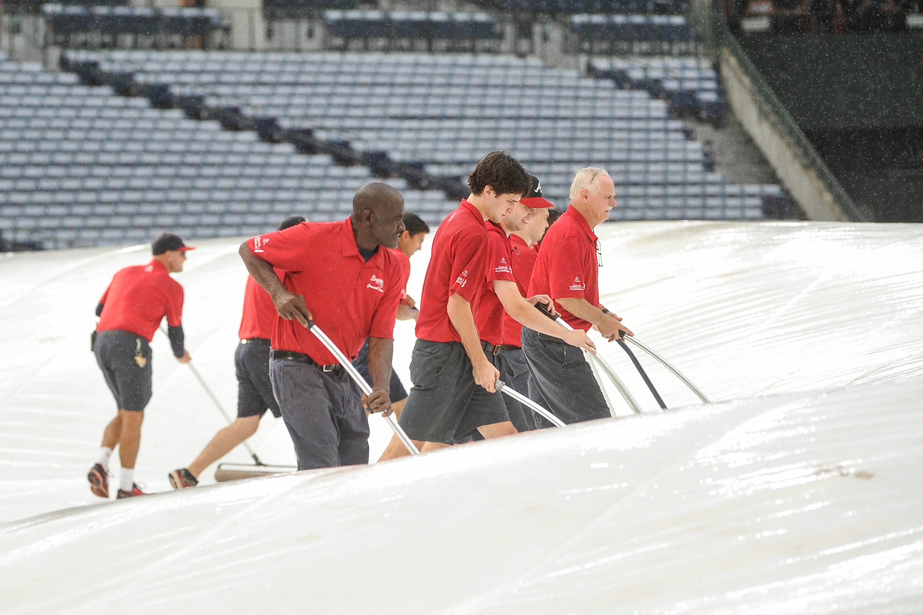 Atlanta Braves grounds crew get the field ready for a baseball game against the Washington Nationals, Saturday, Aug. 20, 2016, in Atlanta. (AP Photo/John Amis)