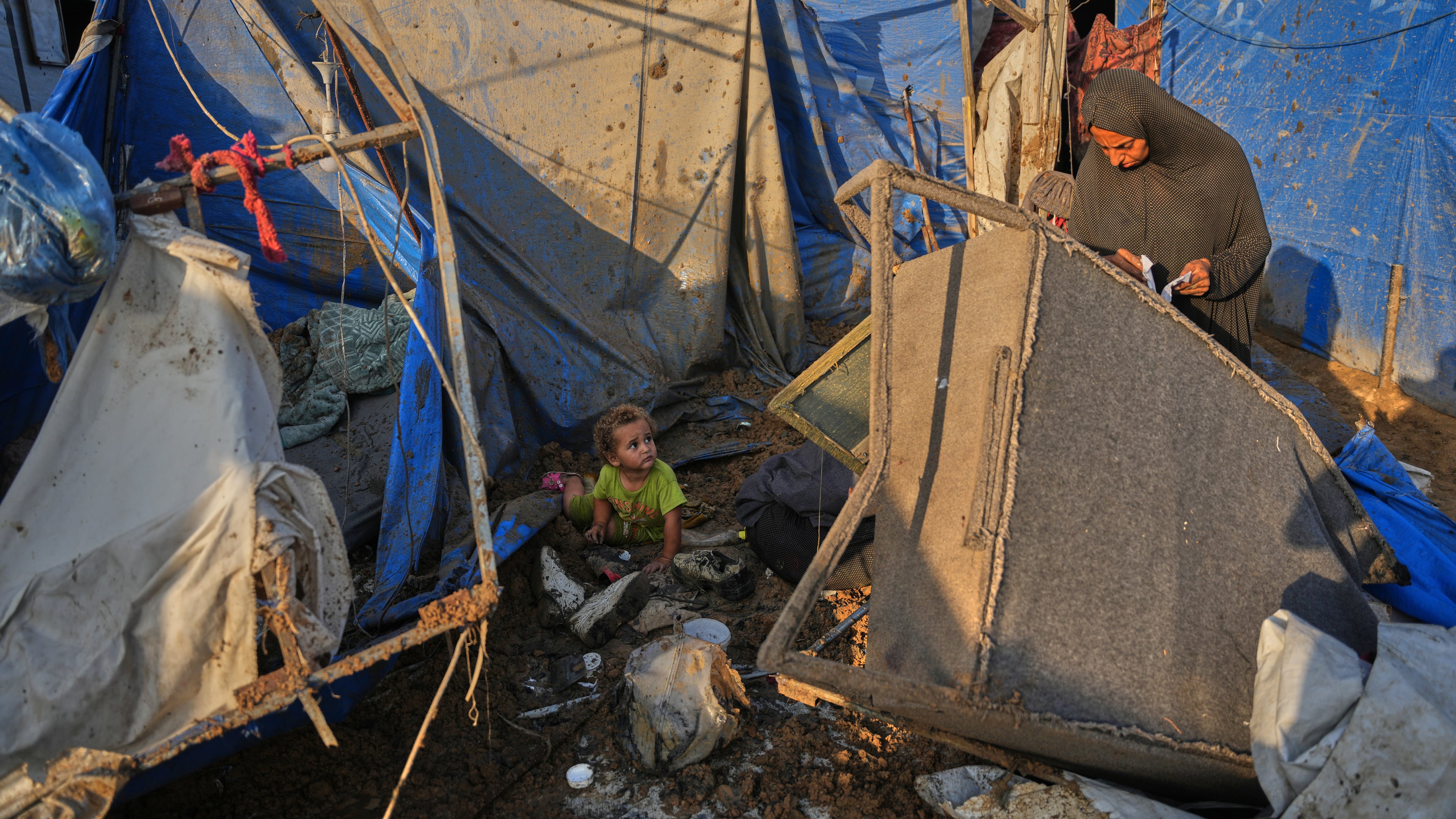 A Palestinian woman inspects the scene of an Israeli airstrike near al-Aqsa Hospital in Deir al-Balah in the central Gaza Strip, Saturday, Aug. 1, 2026. (AP Photo/Abdel Kareem Hana)