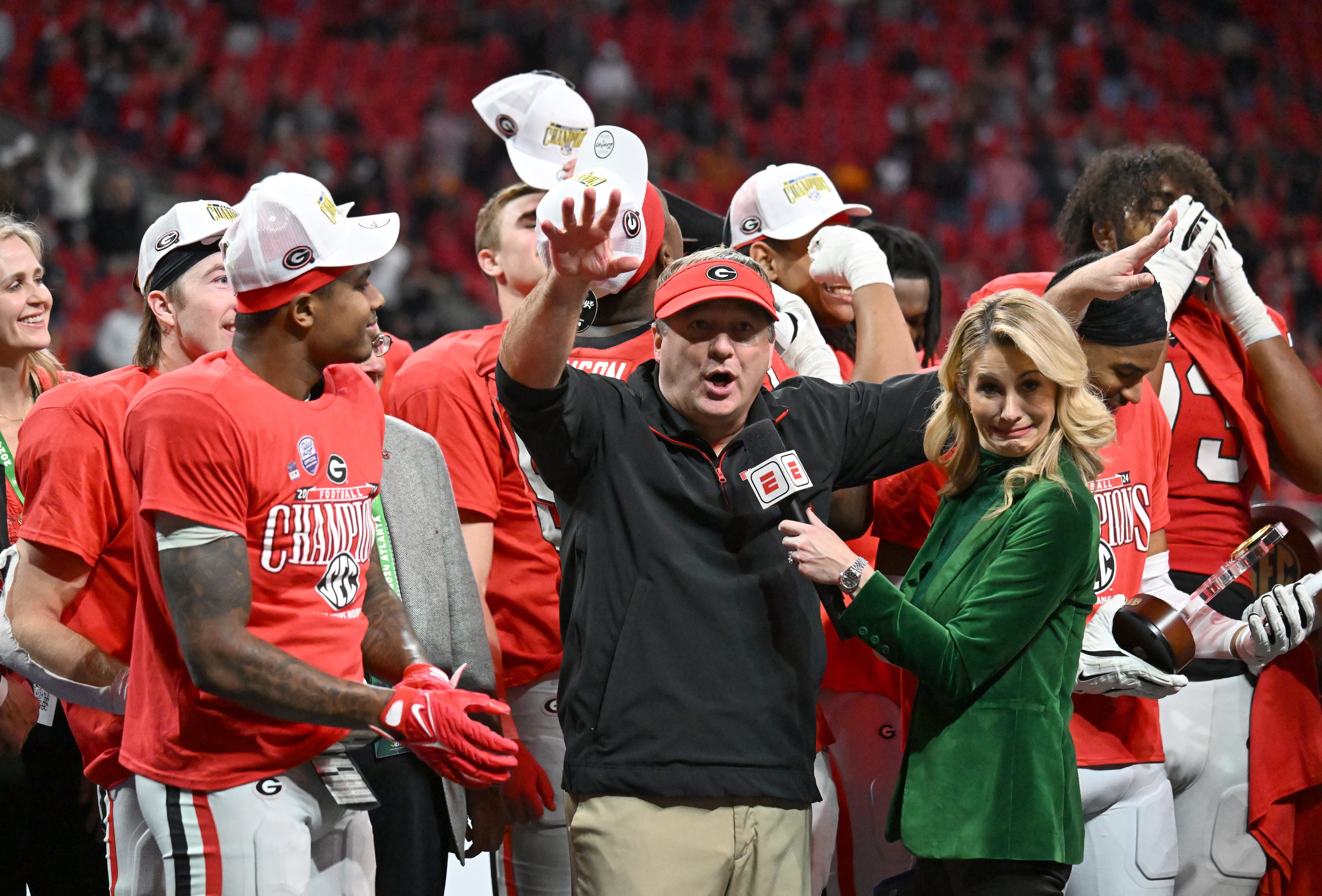 Georgia head coach Kirby Smart and players celebrate victory over Texas in overtime during the SEC Championship football game at the Mercedes-Benz Stadium, Saturday, December 7, 2024, in Atlanta. Georgia won 22-19 over Texas in overtime. (Hyosub Shin / AJC)
