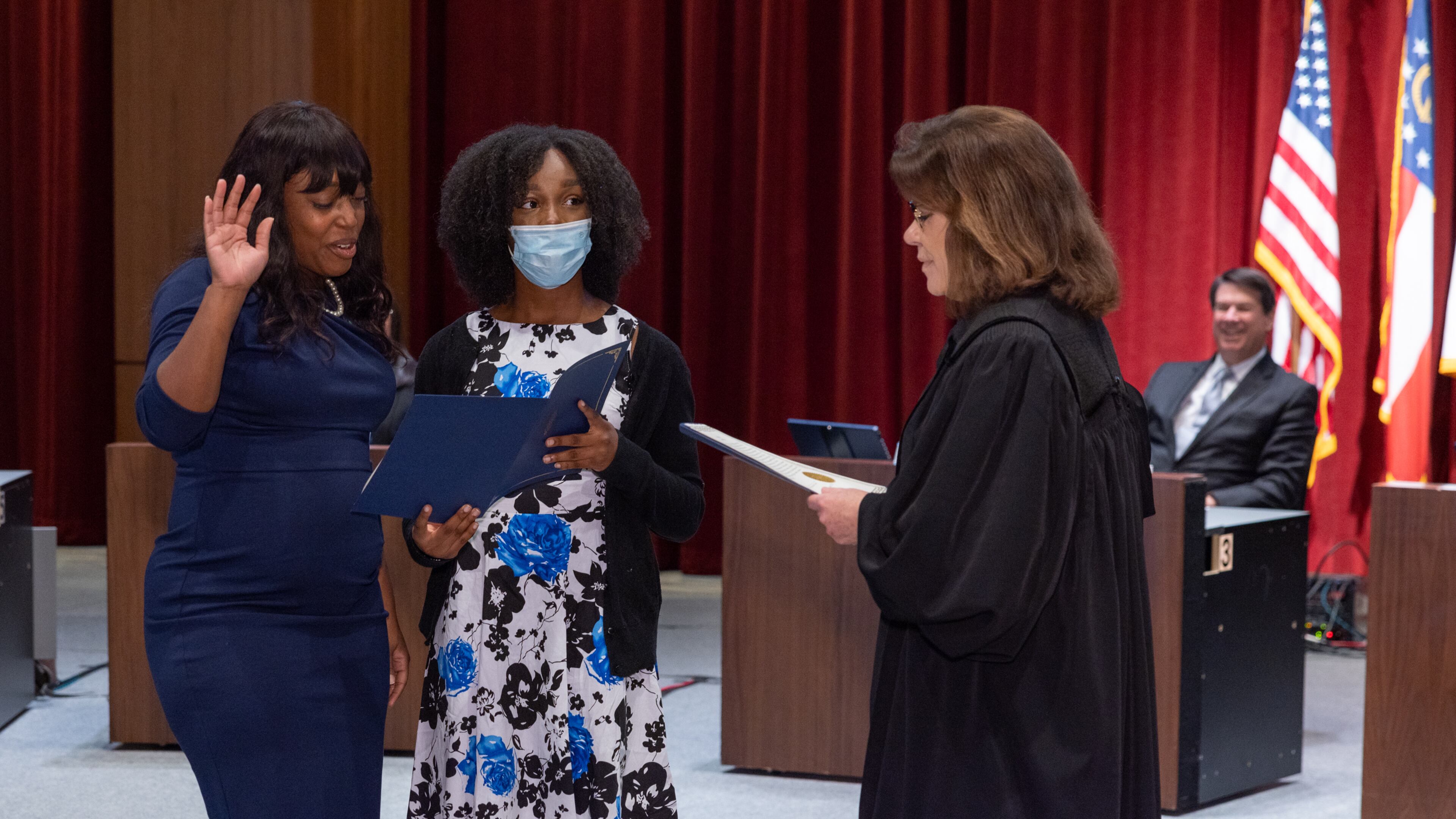 Melody Kelley, Sandy Springs first Black elected official, was sworn into office Tuesday with her daughter, Kiara, holding the oath of office document that she read from aloud.