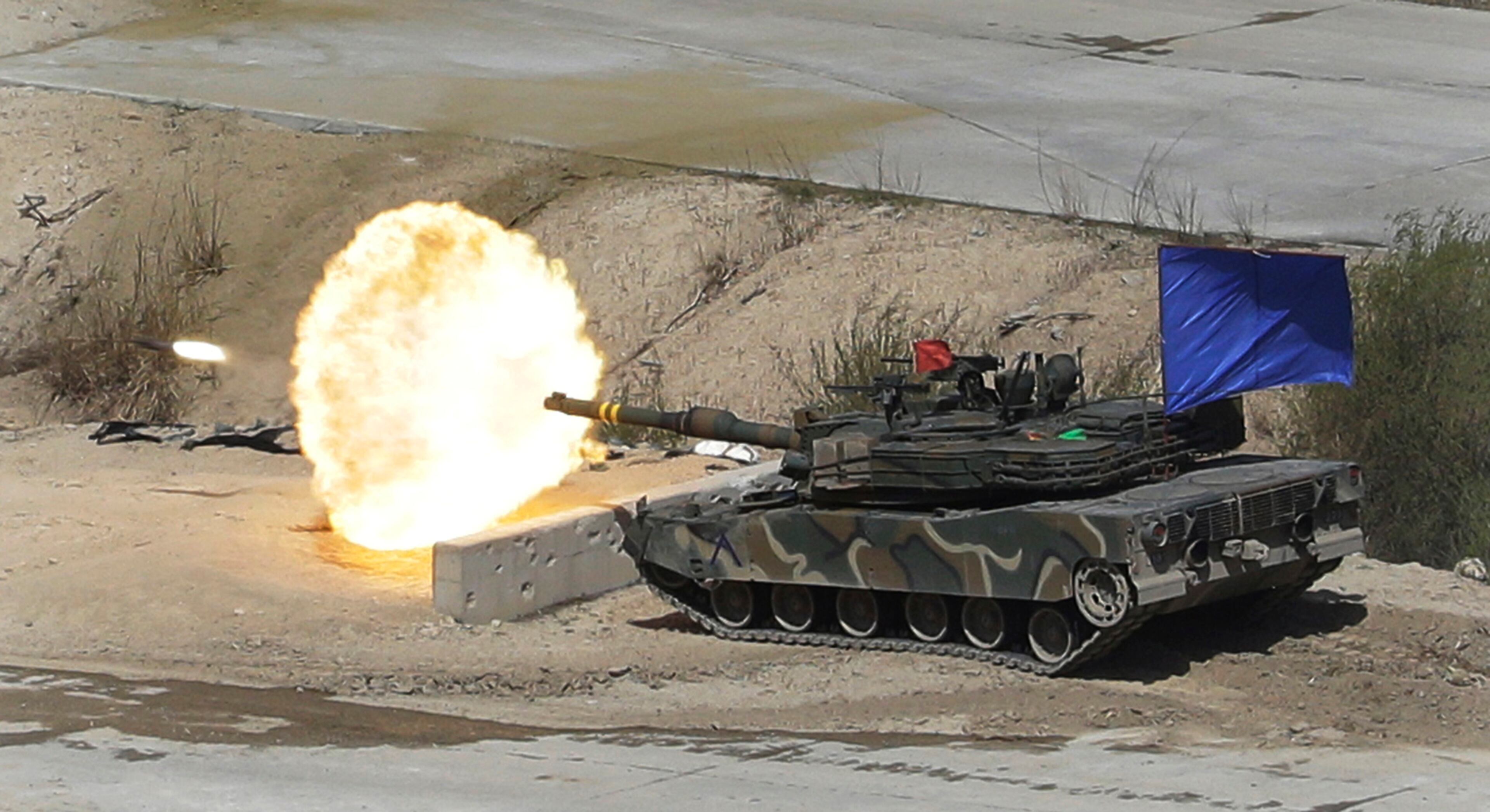 A South Korean army's K1A2 tank fires during South Korea-U.S. joint military live-fire drills at Seungjin Fire Training Field in Pocheon, South Korea, near the border with North Korea, Wednesday. April 26, 2017. (AP Photo/Ahn Young-joon)