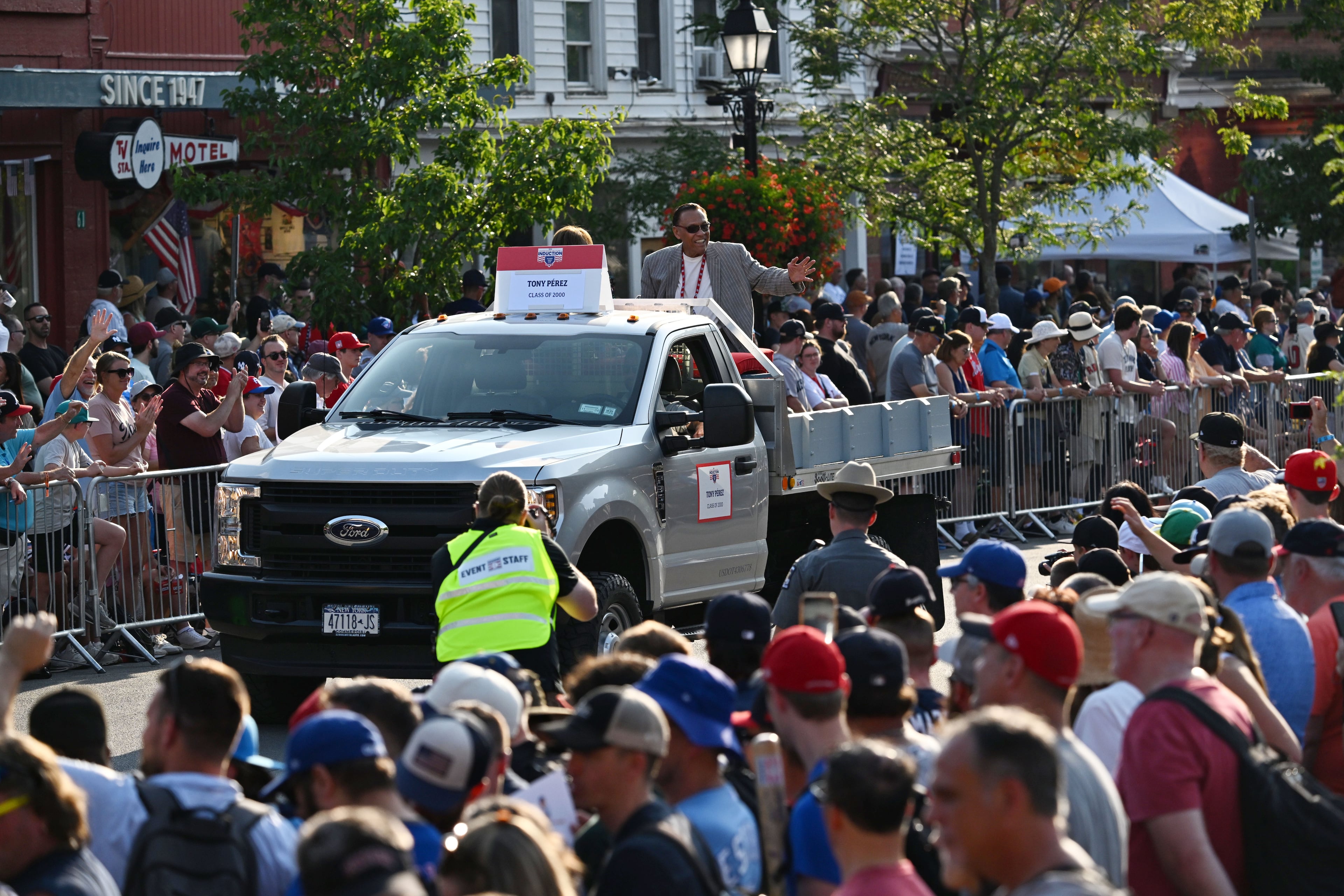 National Baseball Hall of Fame member Tony Perez waves to spectators from the back of a pickup truck during the Hall of Fame Legends Parade on Saturday, July 25, 2026, in Cooperstown, N.Y. Former Brave Andruw Jones will be inducted into the National Baseball Hall of Fame on Sunday as part of the Class of 2026, alongside Carlos Beltrán and Jeff Kent. (Hyosub Shin/AJC)
