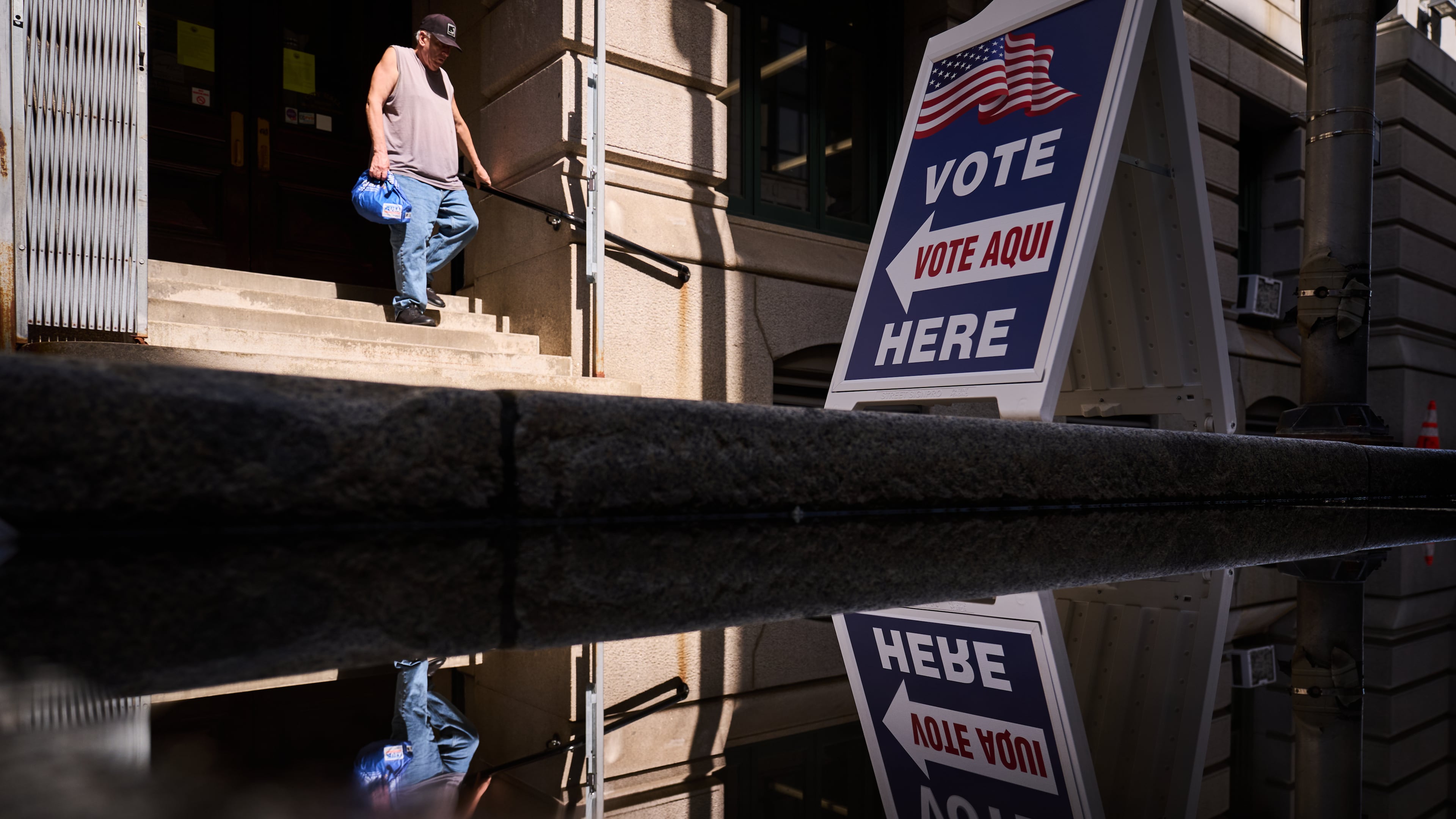 A sign directs voters to an entrance for City Hall during early voting for the Rhode Island primary election, Wednesday, Sept. 2, 2026, in Providence, R.I. (AP Photo/David Goldman)