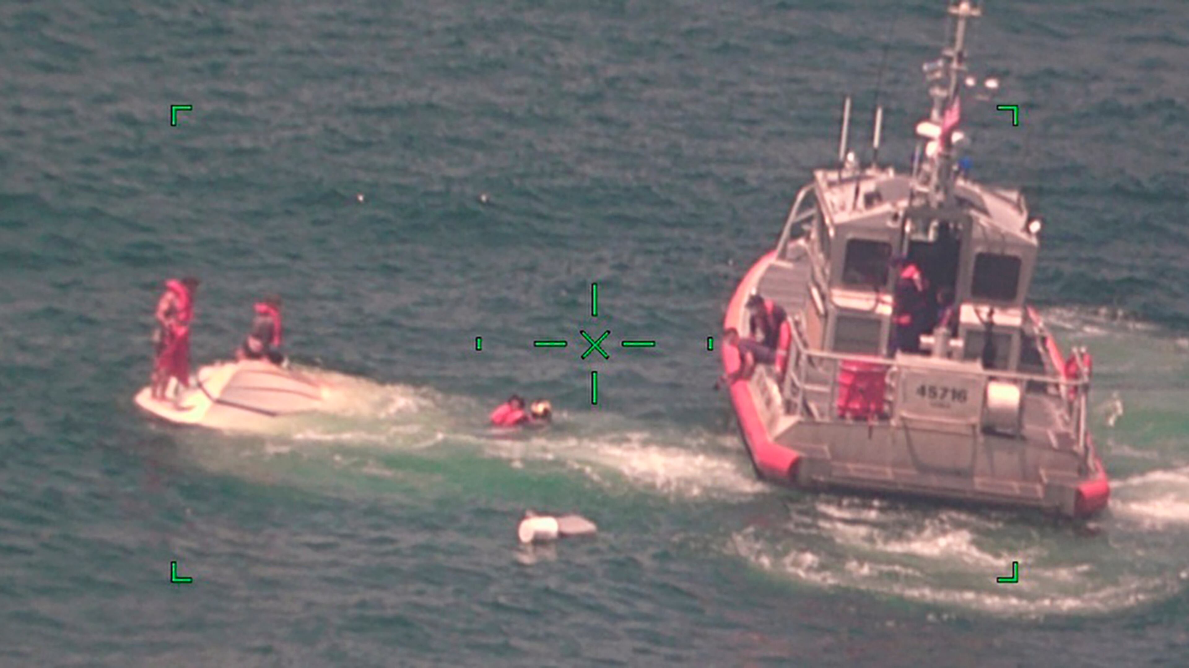 In this photo released by the U.S. Coast Guard, members of the Coast Guard rescue a family of four Wednesday from a vessel taking on water 17 miles south of Southwest Pass near Venice, Louisiana.