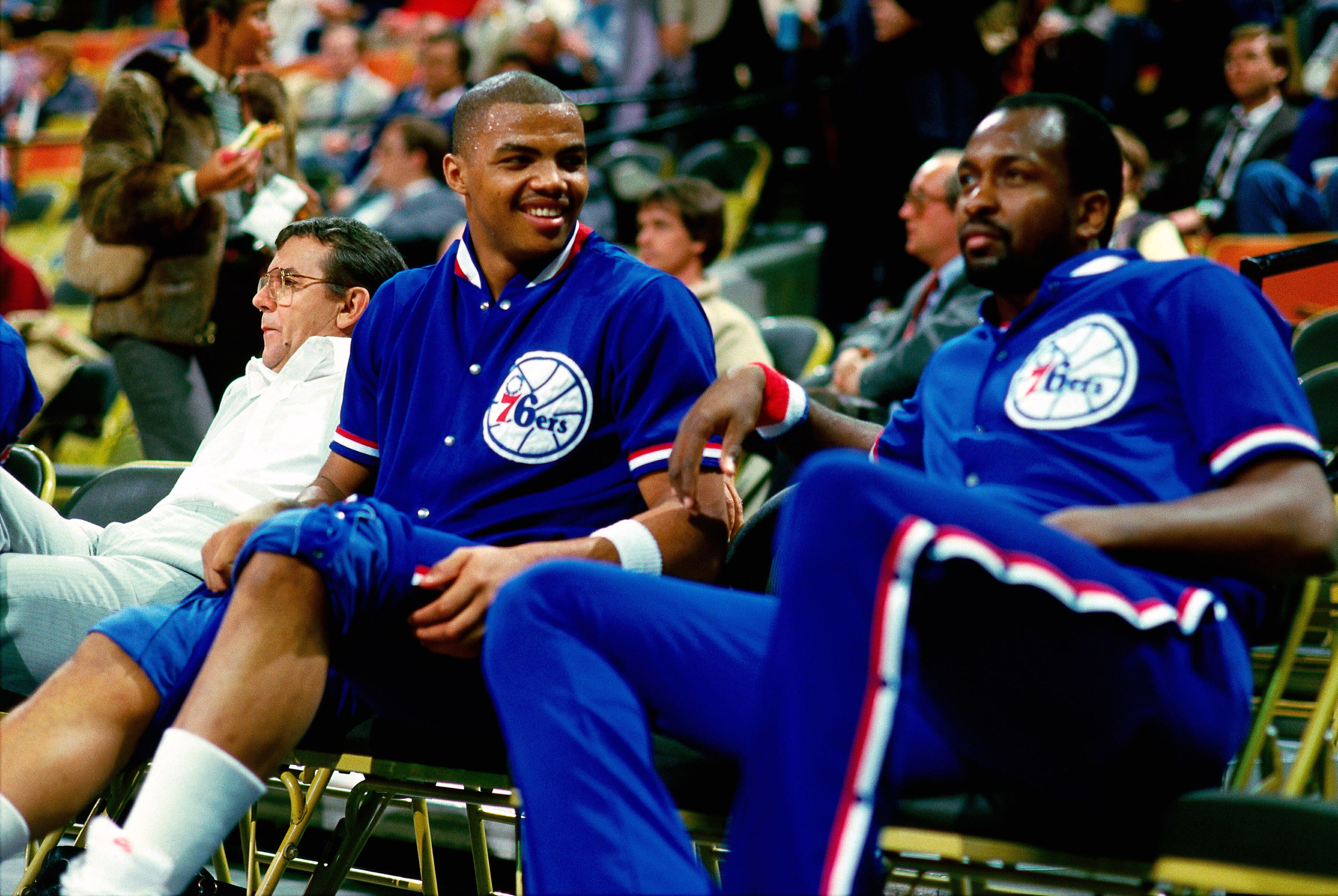 PHILADELPHIA - 1985: (L-R) Charles Barkley #34 of the Philadelphia 76ers shares a light moment with teammate Moses Malone #2 while resting on the bench during an NBA game in 1985 at The Spectrum in Philadelphia, Pennsylvania. NOTE TO USER: User expressly acknowledges and agrees that, by downloading and/or using this Photograph, user is consenting to the terms and conditions of the Getty Images License Agreement. Mandatory Copyright Notice: Copyright 1985 NBAE (Photo by Ron Koch/NBAE via Getty Images)