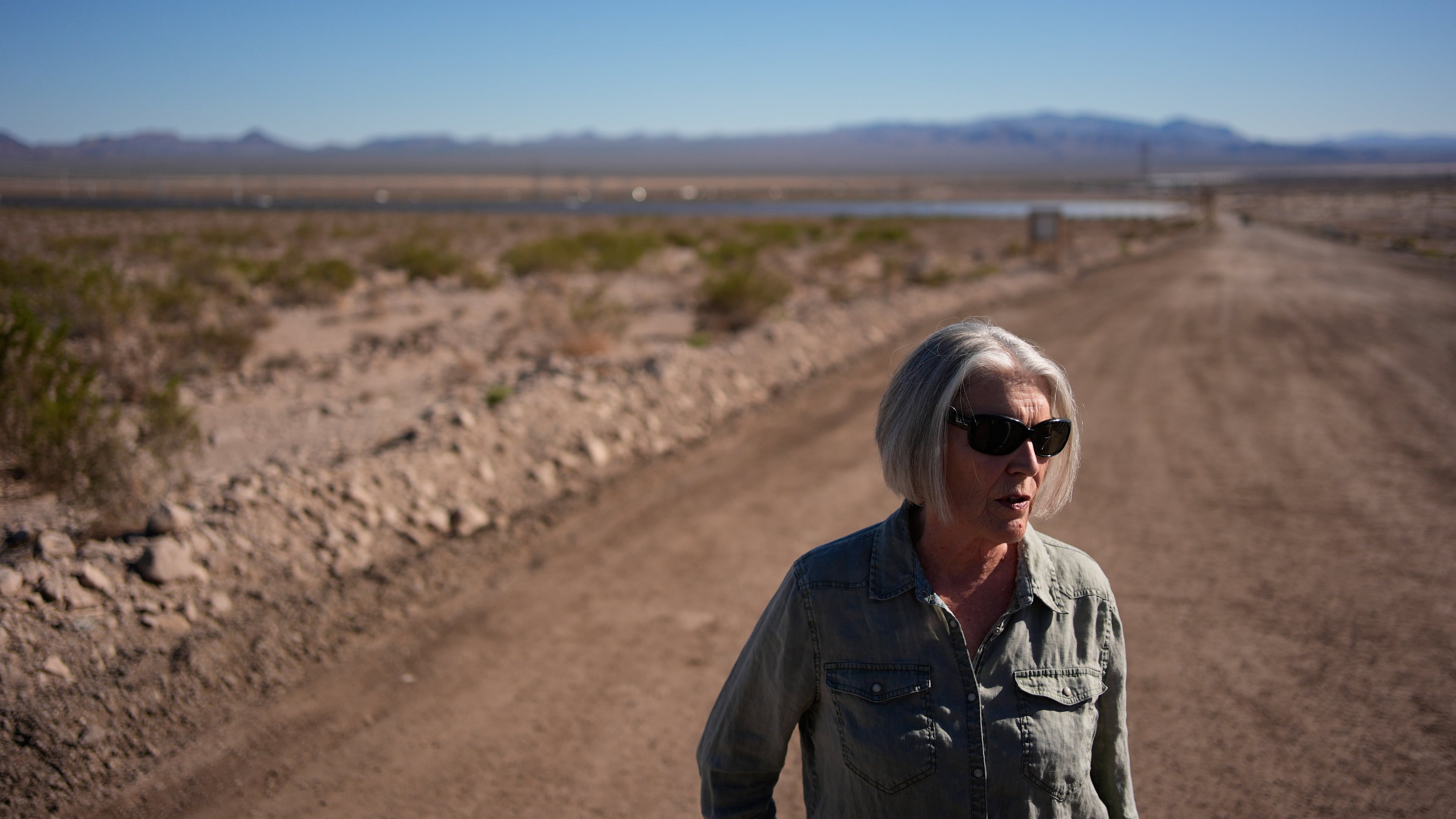 Janelle Sorenson stands beside land for a proposed data center Friday, Oct. 2, 2026, near Boulder City, Nev. (AP Photo/John Locher)