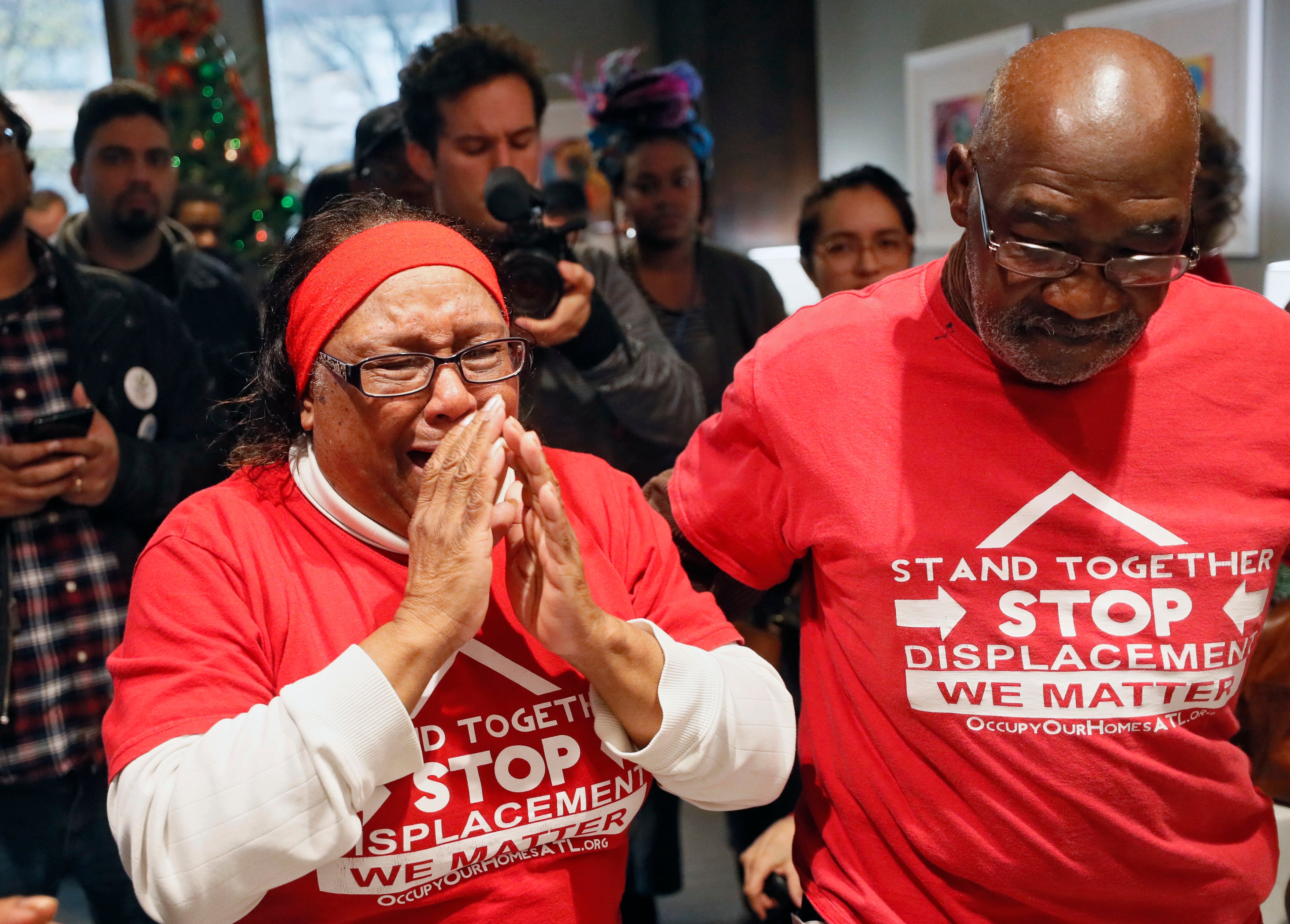 Bertha Darden, who joined other Peoplestown residents in a legal battle to try to keep their homes, talks with Rashad Taylor (far right), a senior advisor to Mayor Keisha Lance Bottoms, as she joined others in occupying the reception area of the mayor's office. The Housing Justice League held a rally at City Hall and a sit-in at the Mayor's Office on December 16, 2019. The protesters want Atlanta Mayor Keisha Lance Bottoms to let Peoplestown residents in the city stay in their homes and not be displaced by eminent domain to build a park and retention pond. Bob Andres / bandres@ajc.com