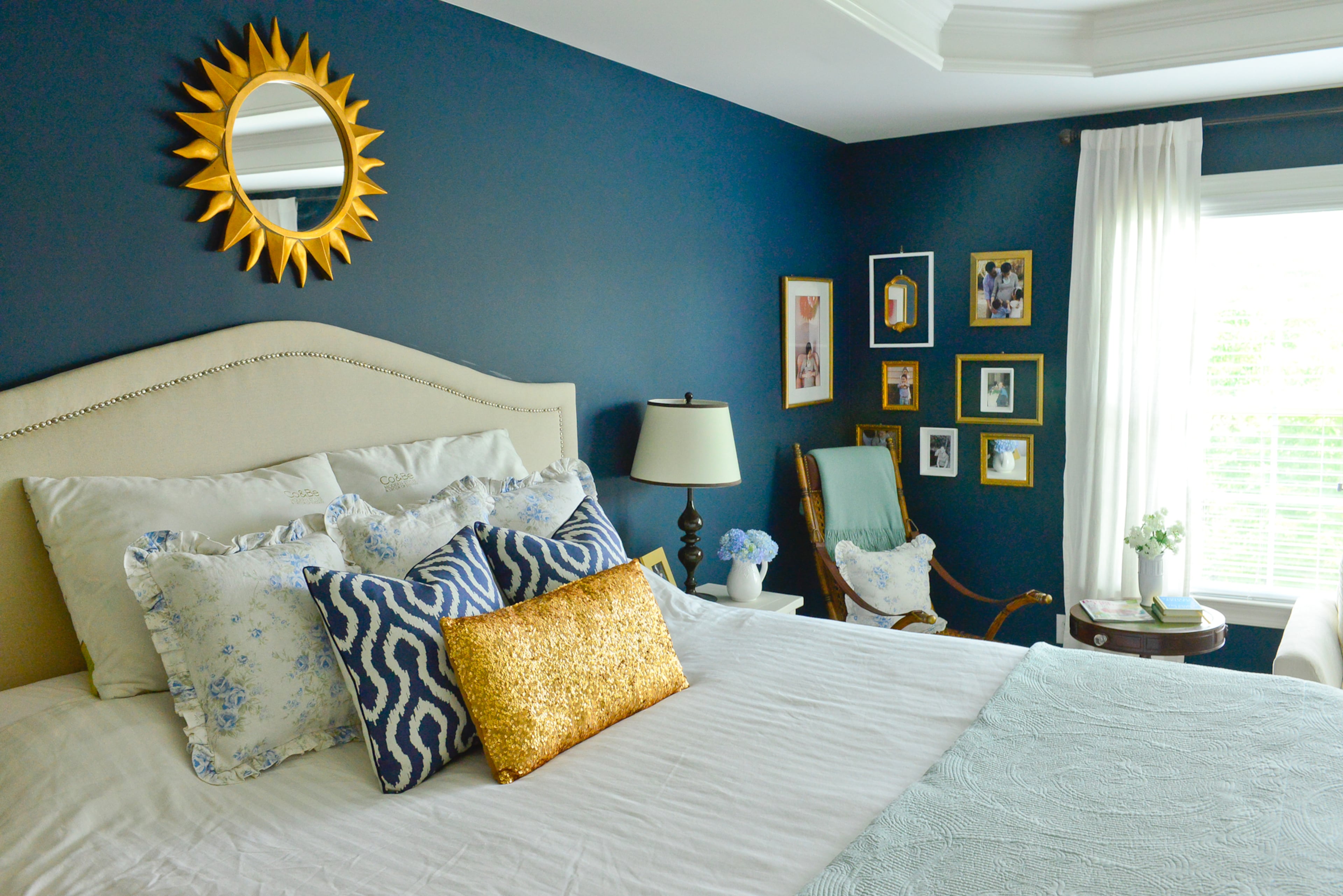 Master bedroom: Antique heirloom chairs bookend the dresser in the master bedroom. Originally from the homeowners' parents, homeowner Yuni Min updated the chairs with gold Rub 'n Buff and new upholstery. The gold framed mirror came from the decor in homeowner Jimmy Min's parents' flower shop after it closed. The dresser is from the original set that the couple bought when they got married, and Yuni has since repainted it and the matching bedside table with cream chalk paint.