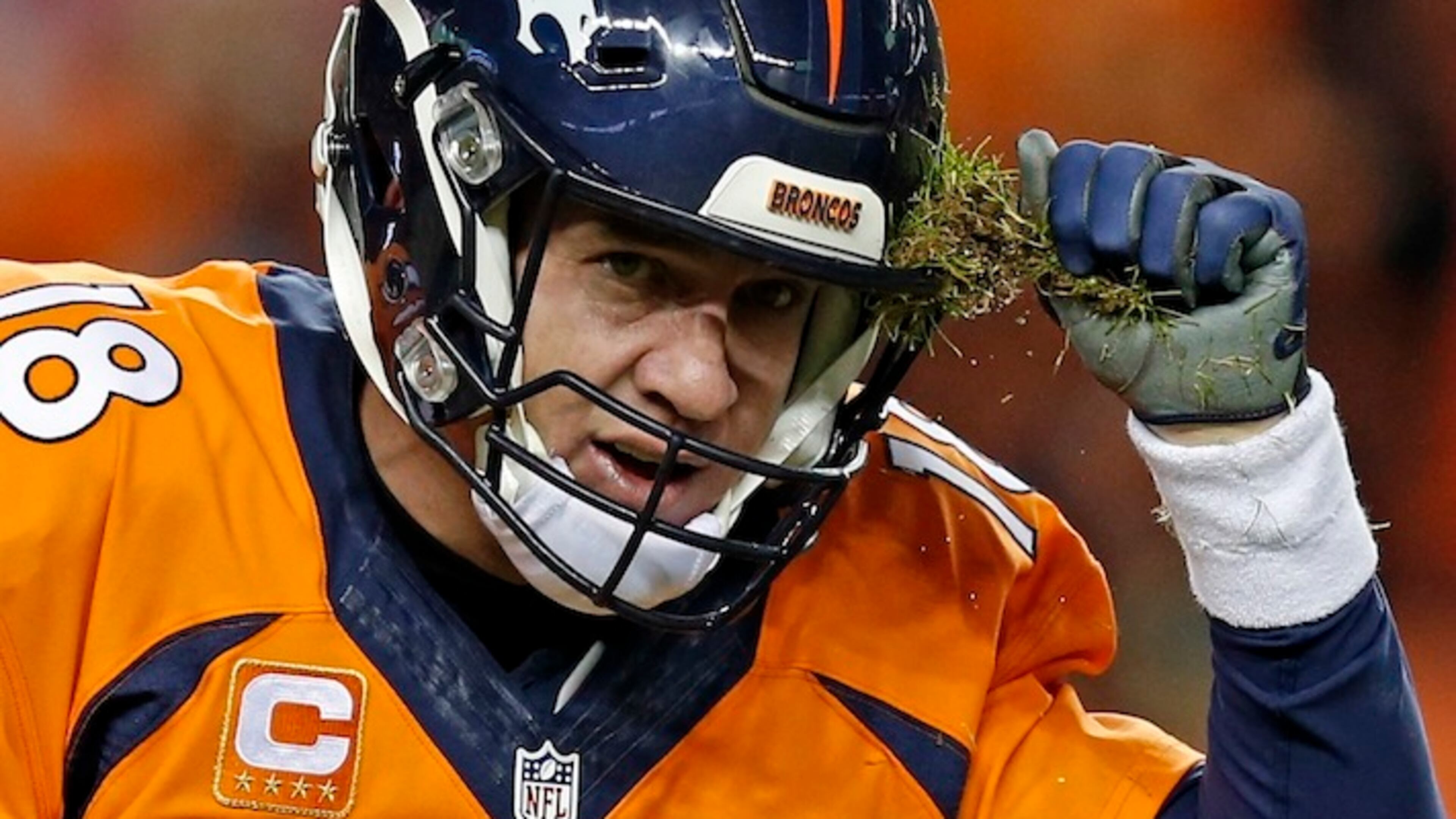 Denver Broncos quarterback Peyton Manning pulls grass off his helmet during the second half in an NFL football game against the San Diego Chargers, Sunday, Jan. 3, 2016, in Denver. (AP Photo/David Zalubowski)