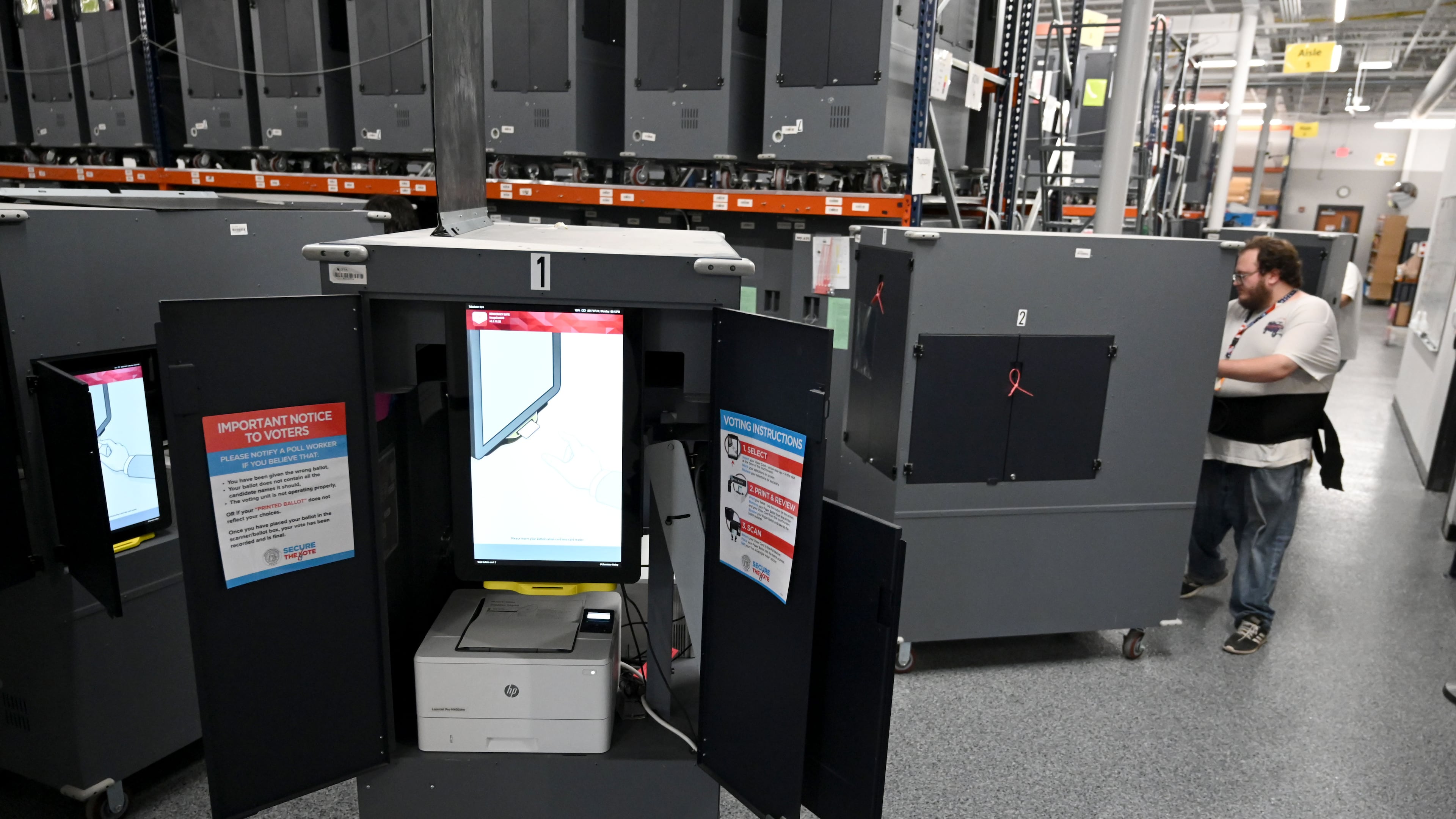 Election workers set up voting hubs before testing ballot marking devices (BMDs) at the Cobb County Elections & Registration building on Tuesday, Sept. 22, 2026, in Marietta. Officials are testing voting touchscreens, ballot scanners and check-in tablets in the run-up to the midterms in an effort to find and mitigate problems before voting starts. (Hyosub Shin/AJC)