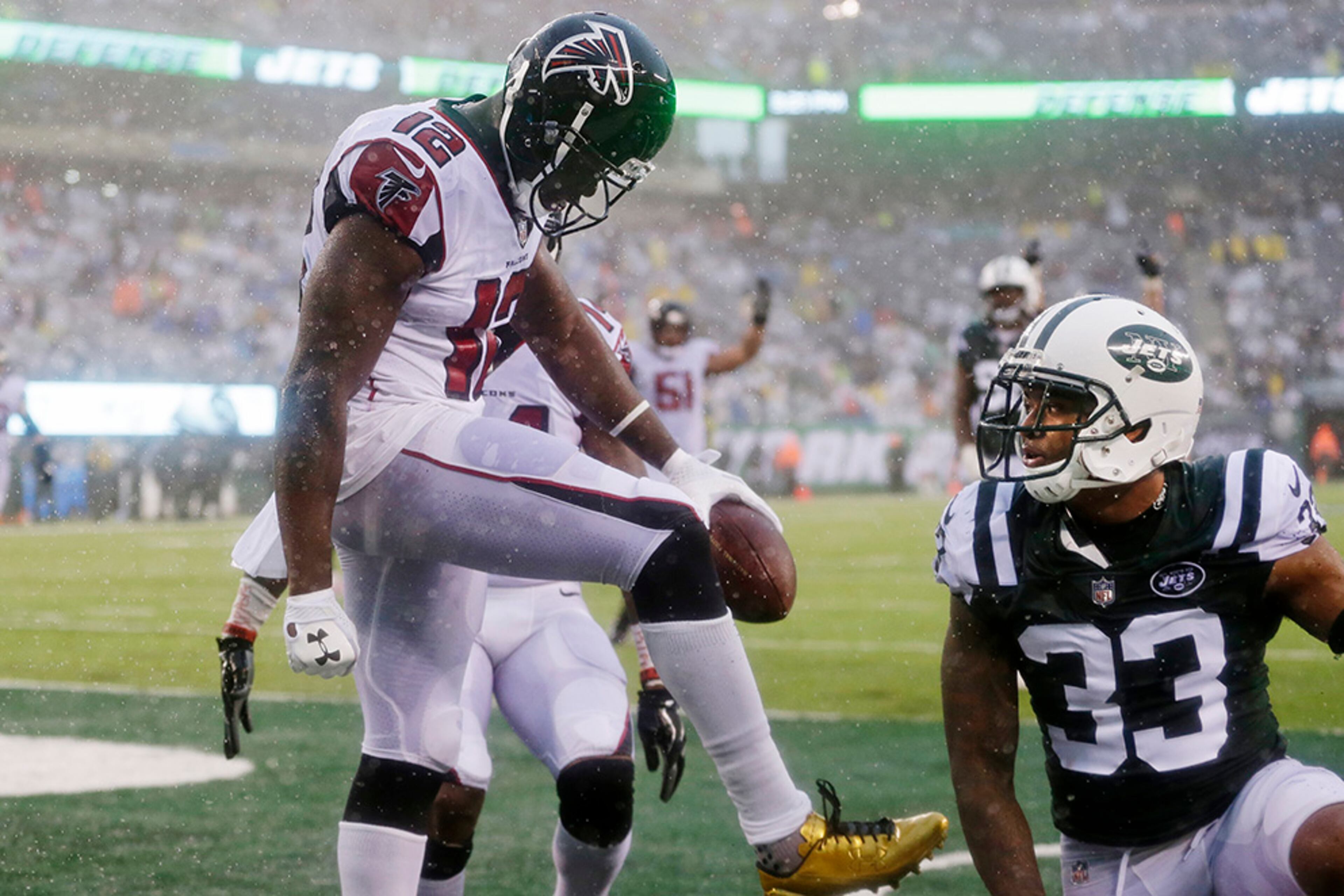 Atlanta Falcons wide receiver Mohamed Sanu (12) celebrates after catching a pass for a touchdown as New York Jets strong safety Jamal Adams (33) reacts during the second half of an NFL football game Sunday, Oct. 29, 2017, in East Rutherford, N.J. (AP Photo/Seth Wenig)