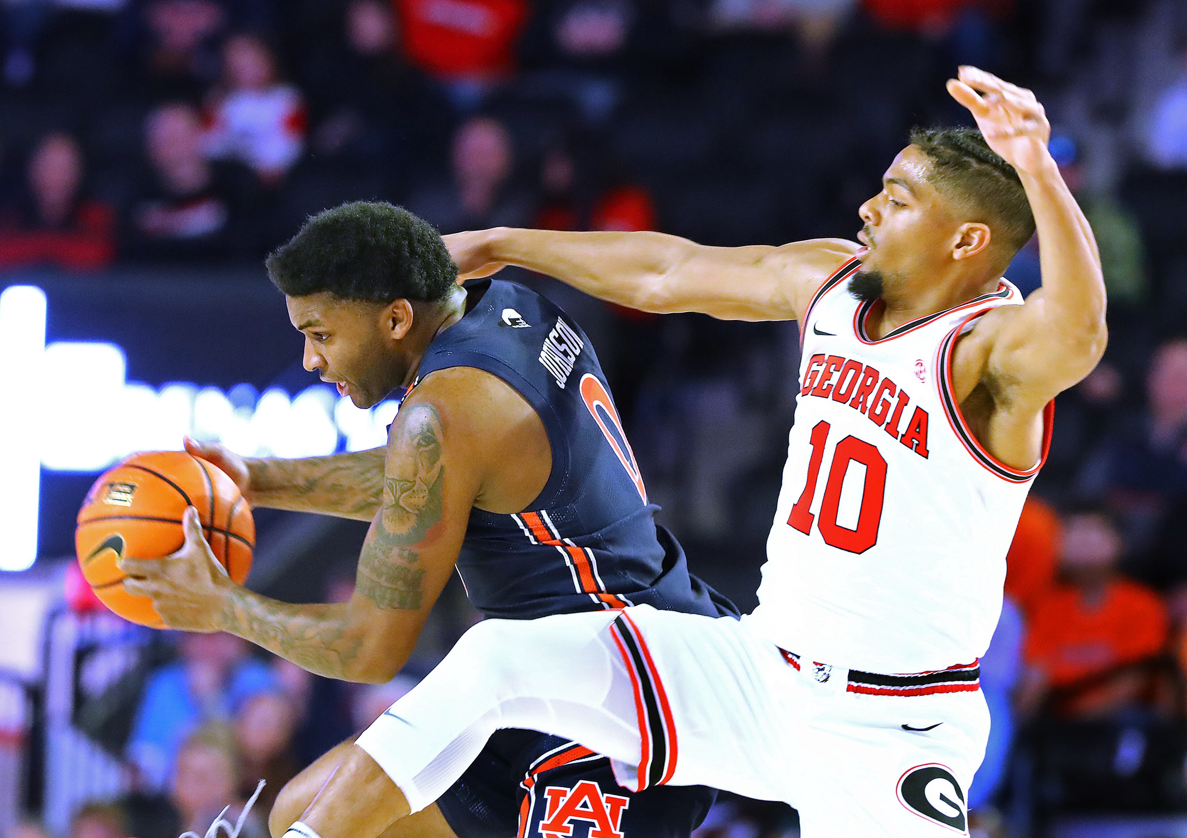 Auburn's K.D. Johnson, a former Georgia player, steals the ball during the first half in a NCAA college basketball game on Saturday, Feb. 5, 2022, in Athens. “Curtis Compton / Curtis.Compton@ajc.com”`