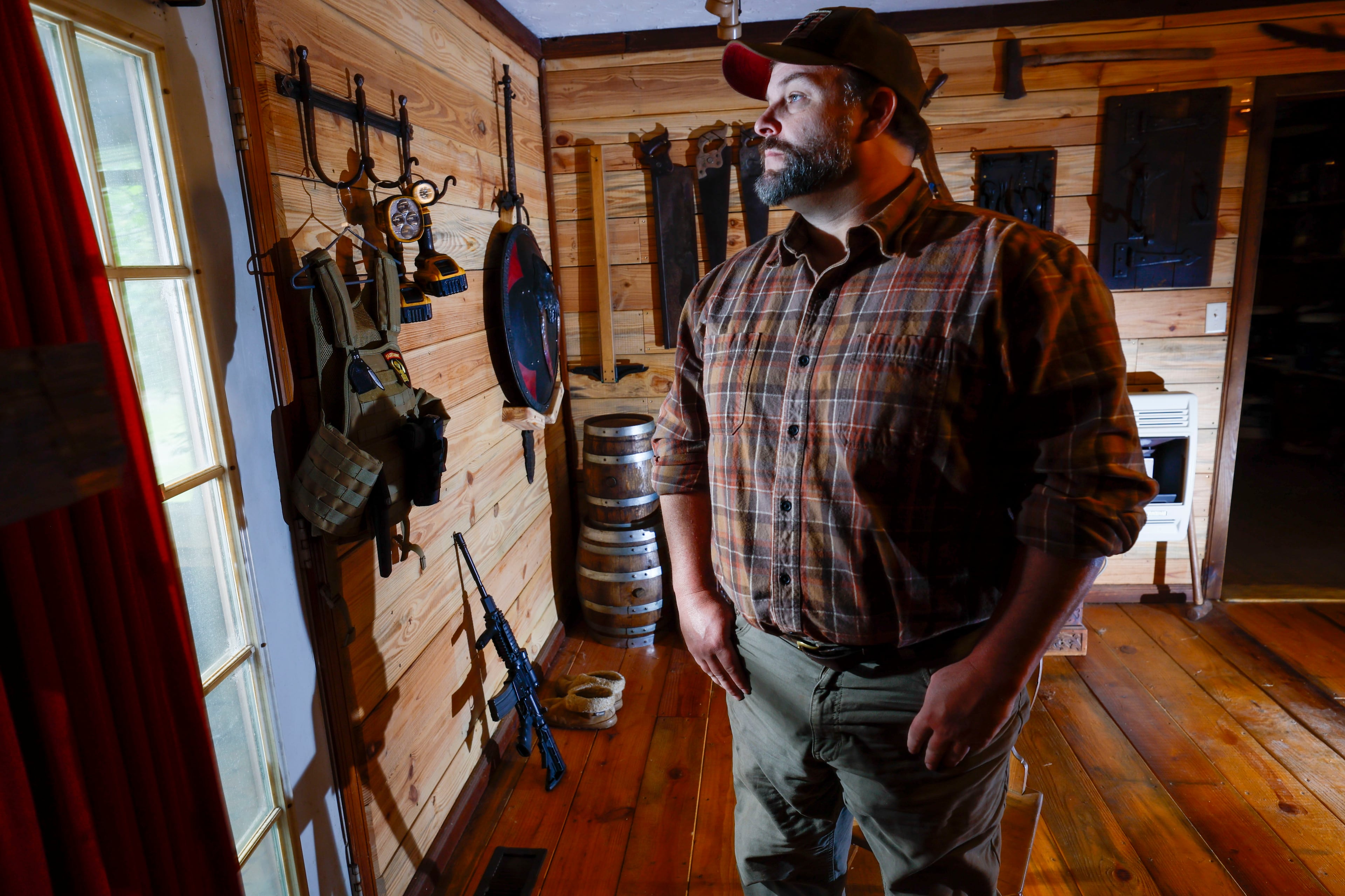 Trent Tye, who lives near Calhoun State Prison, says that drug trafficking near the facility is so common that he keeps an AR 15 and tactical gear near his back door. (Miguel Martinez/ AJC)