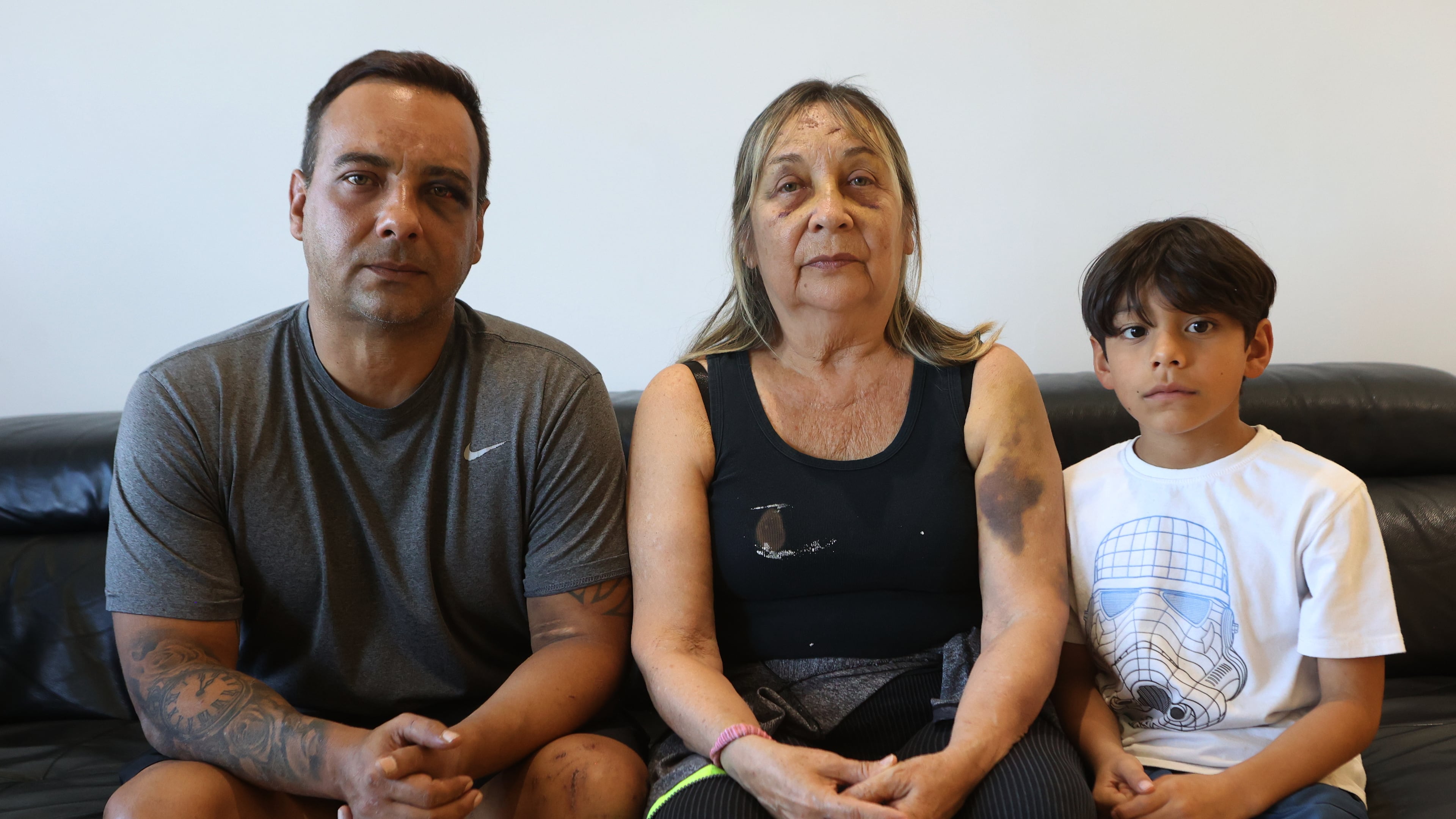 Grian Serrano, left, his mother, Ingrid Rochabrun, and his son, Gael, sit at the home where they are staying with relatives in Caracas, Venezuela, after surviving the back-to-back earthquakes that destroyed their apartment building in Caraballeda, Monday, June 29, 2026. Serrano also survived the 1999 mudslides that struck La Guaira. (AP Photo/Pedro Mattey)