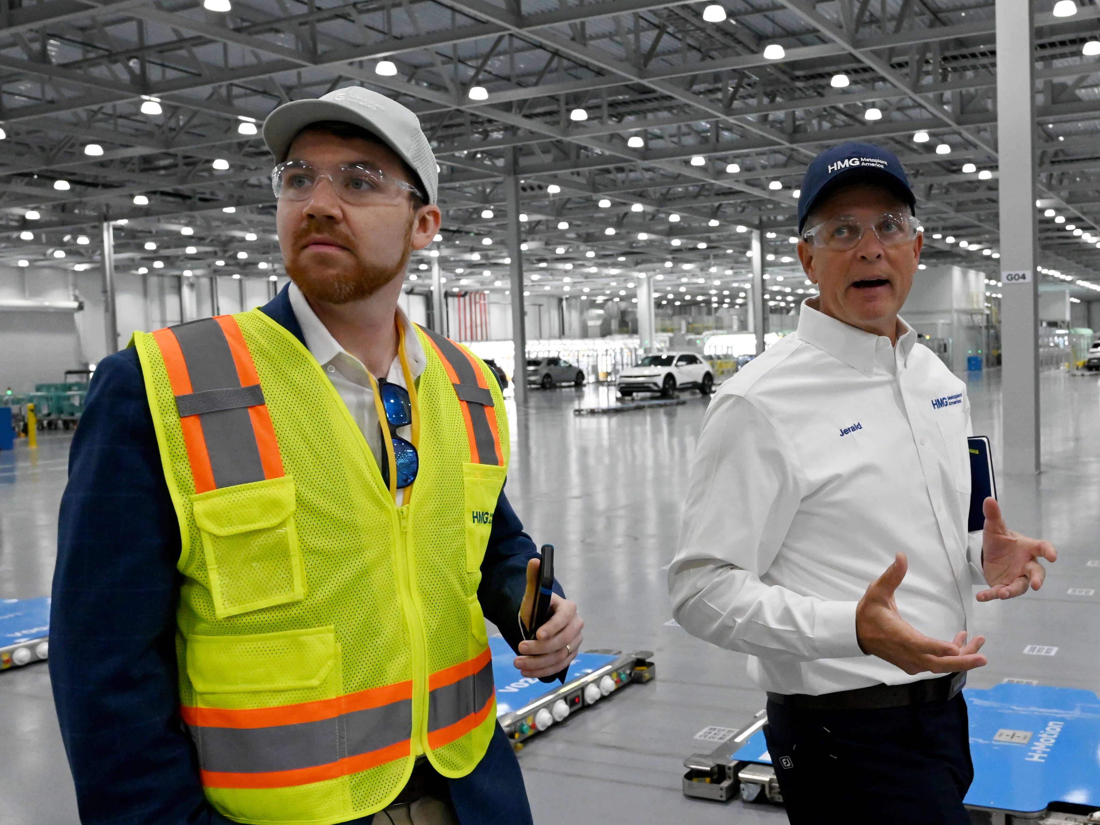 Jerald Roach (right), a Hyundai Metaplant executive, talks to AJC reporter Zachary Hansen as he leads a tour of the automaker's factory in Bryan County on May 6, 2026. (Hyosub Shin/AJC)