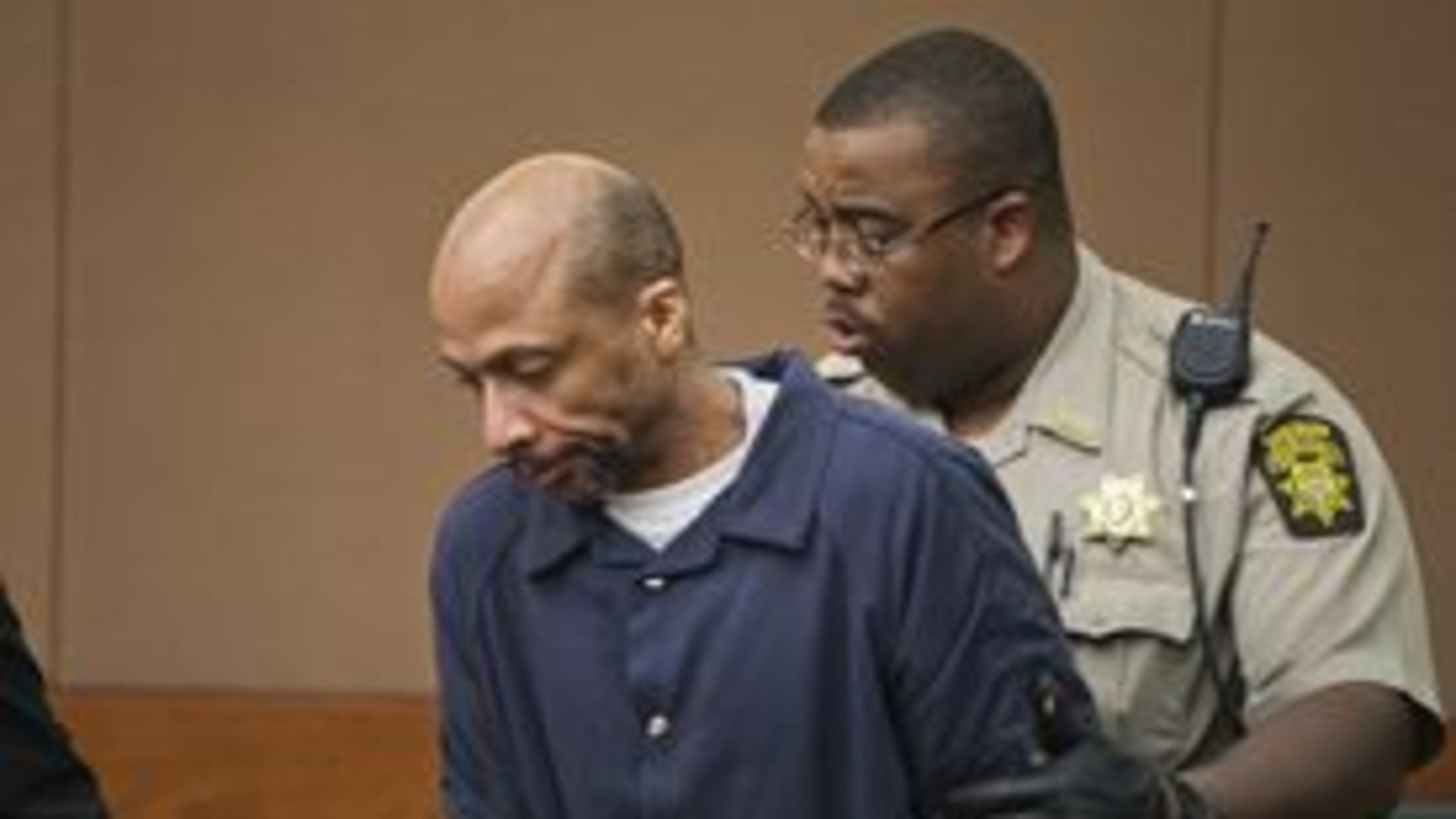 In this Jan. 11, 2013, file photo, Fulton County Sheriff A. Burgess leads Floyd Palmer into a courtroom. JOHN SPINK / JSPINK@AJC.COM