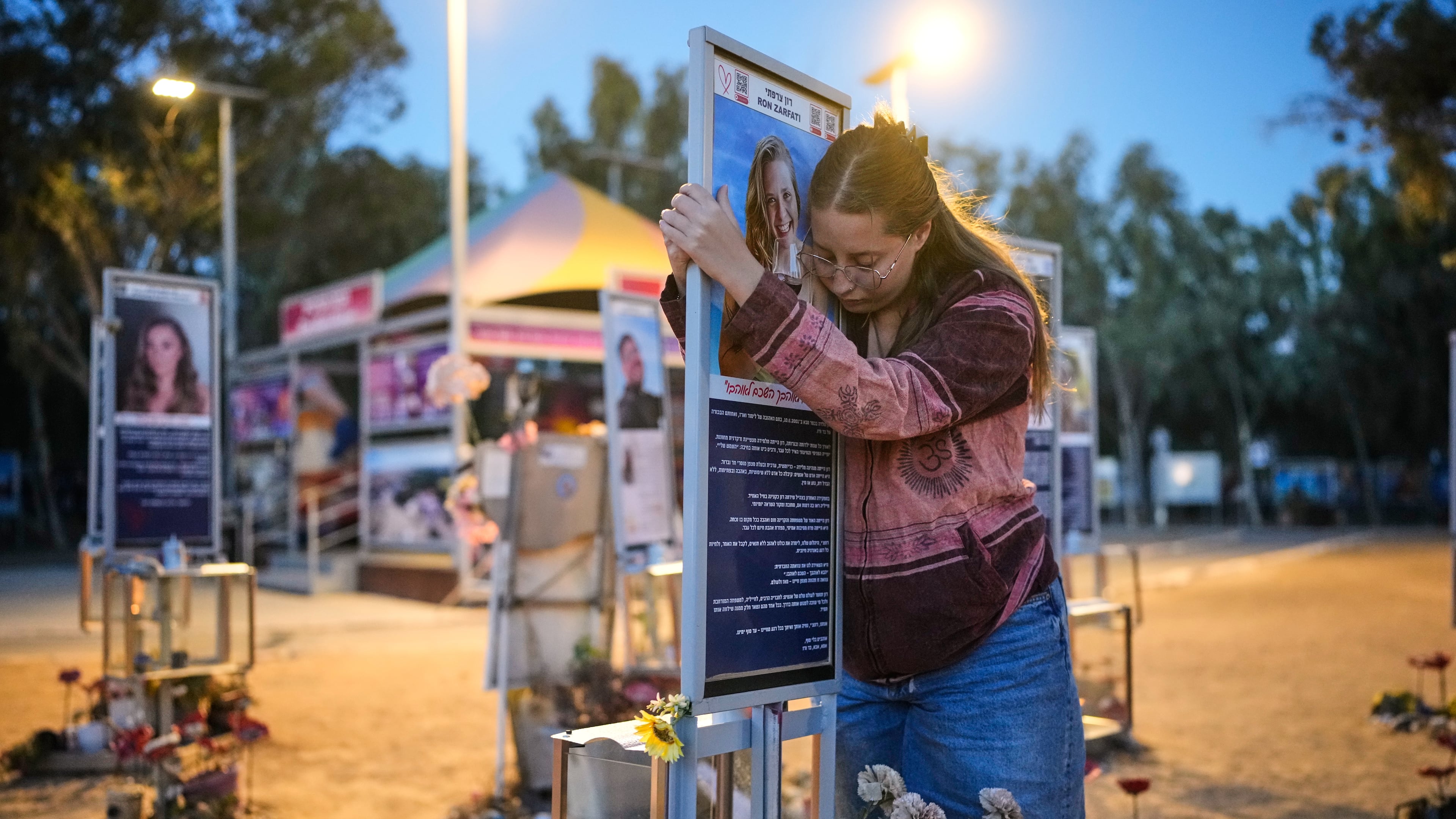 Raz Zarfati, sister of Ron Zarfati who was killed in the Oct. 7, 2023, Hamas attack on Israel, attend a memorial marking the third anniversary of the attack at the Nova music festival site near Kibbutz Reim, southern Israel, Wednesday, Oct. 7, 2026. (AP Photo/Ohad Zwigenberg)