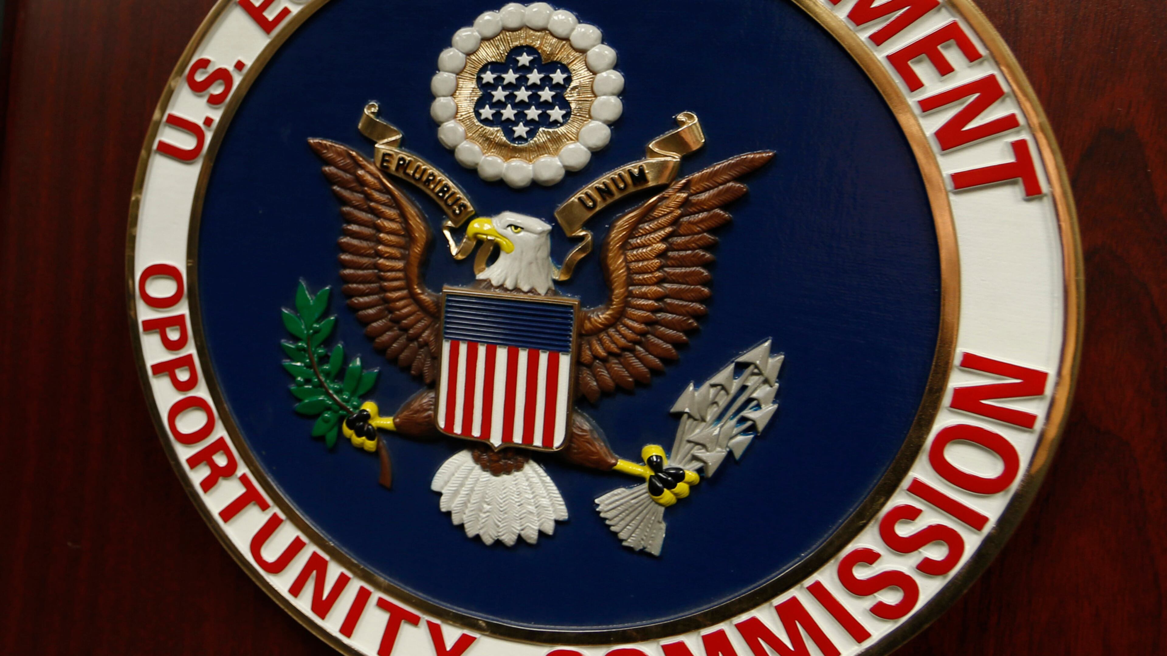 FILE - The emblem of the U.S. Equal Employment Opportunity Commission (EEOC) is displayed on a podium in Vail, Colo., Feb. 16, 2016. (AP Photo/David Zalubowski, File)