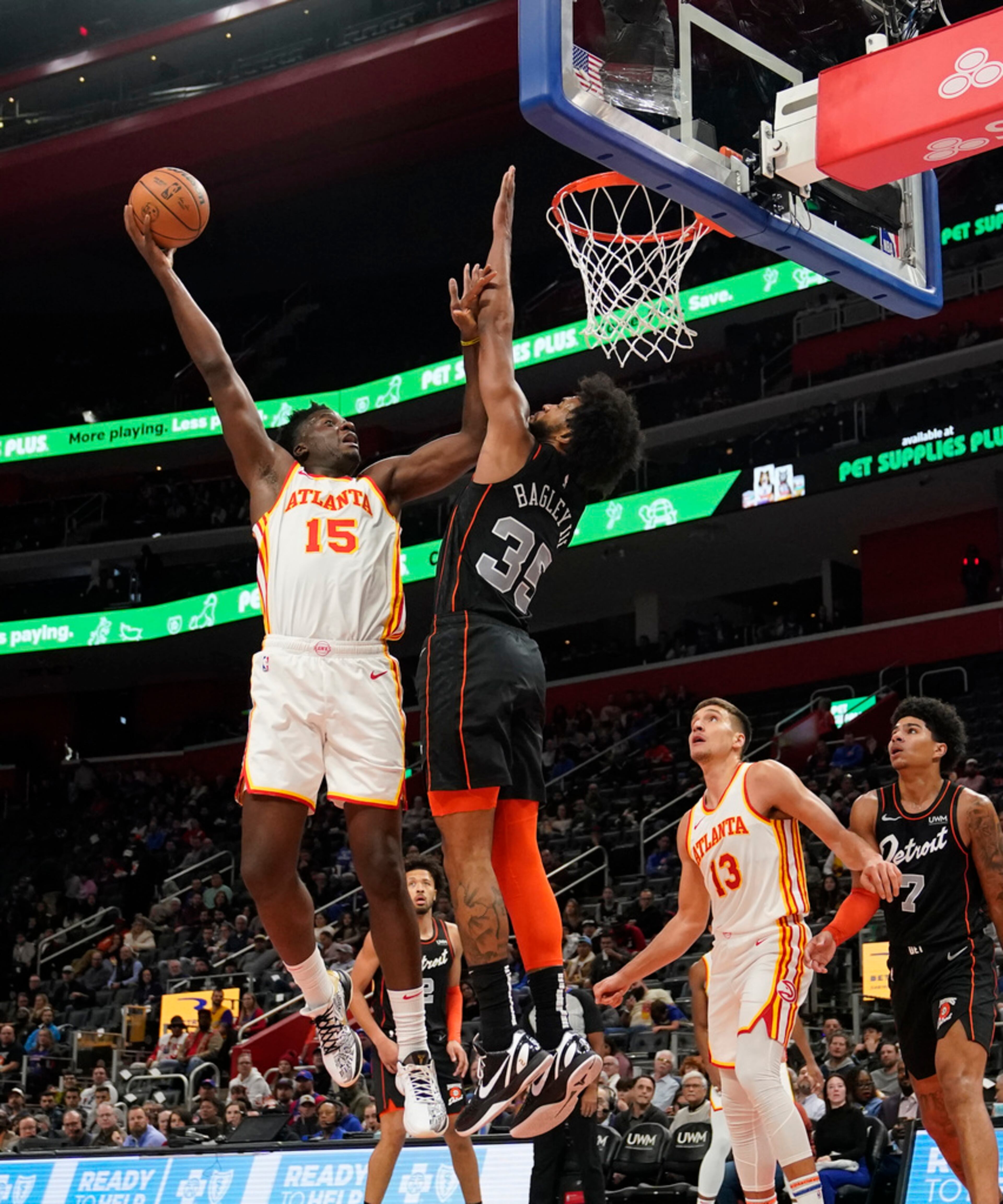 Atlanta Hawks center Clint Capela (15) shoots over the defense of Detroit Pistons forward Marvin Bagley III (35) during the first half of an NBA basketball game, Tuesday, Nov. 14, 2023, in Detroit. (AP Photo/Carlos Osorio)
