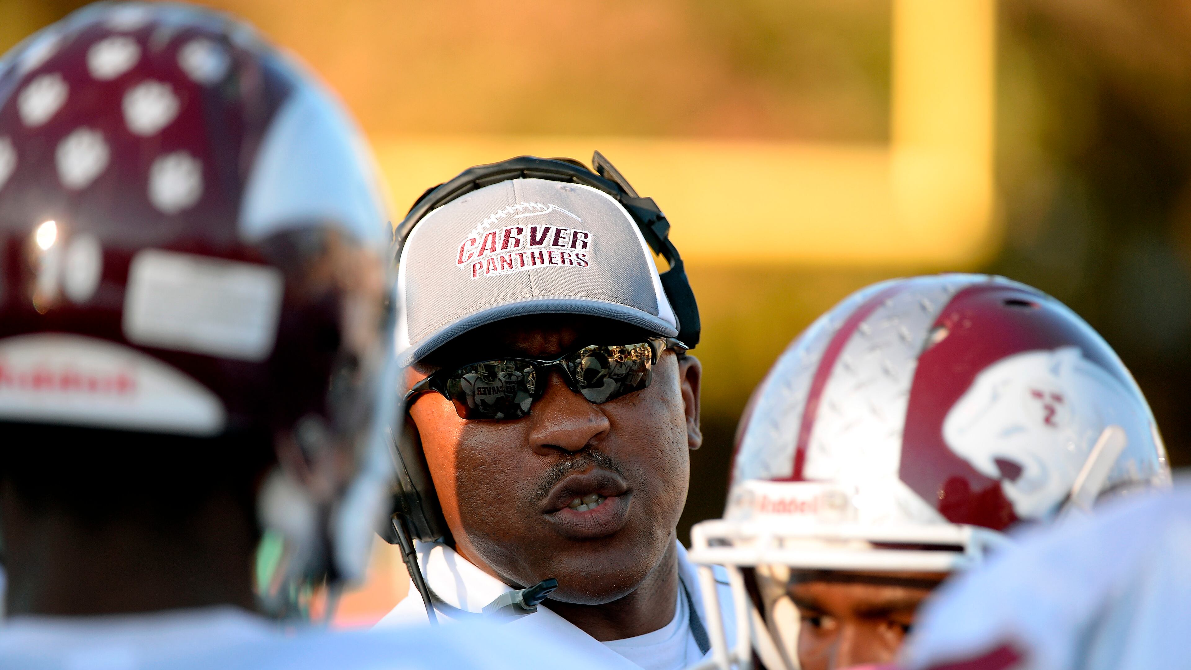 Carver head football coach Darren Myles instructs his players in the first half of their high school football game against Grady on Friday, Nov. 1, 2013, at Grady Stadium in Atlanta.
