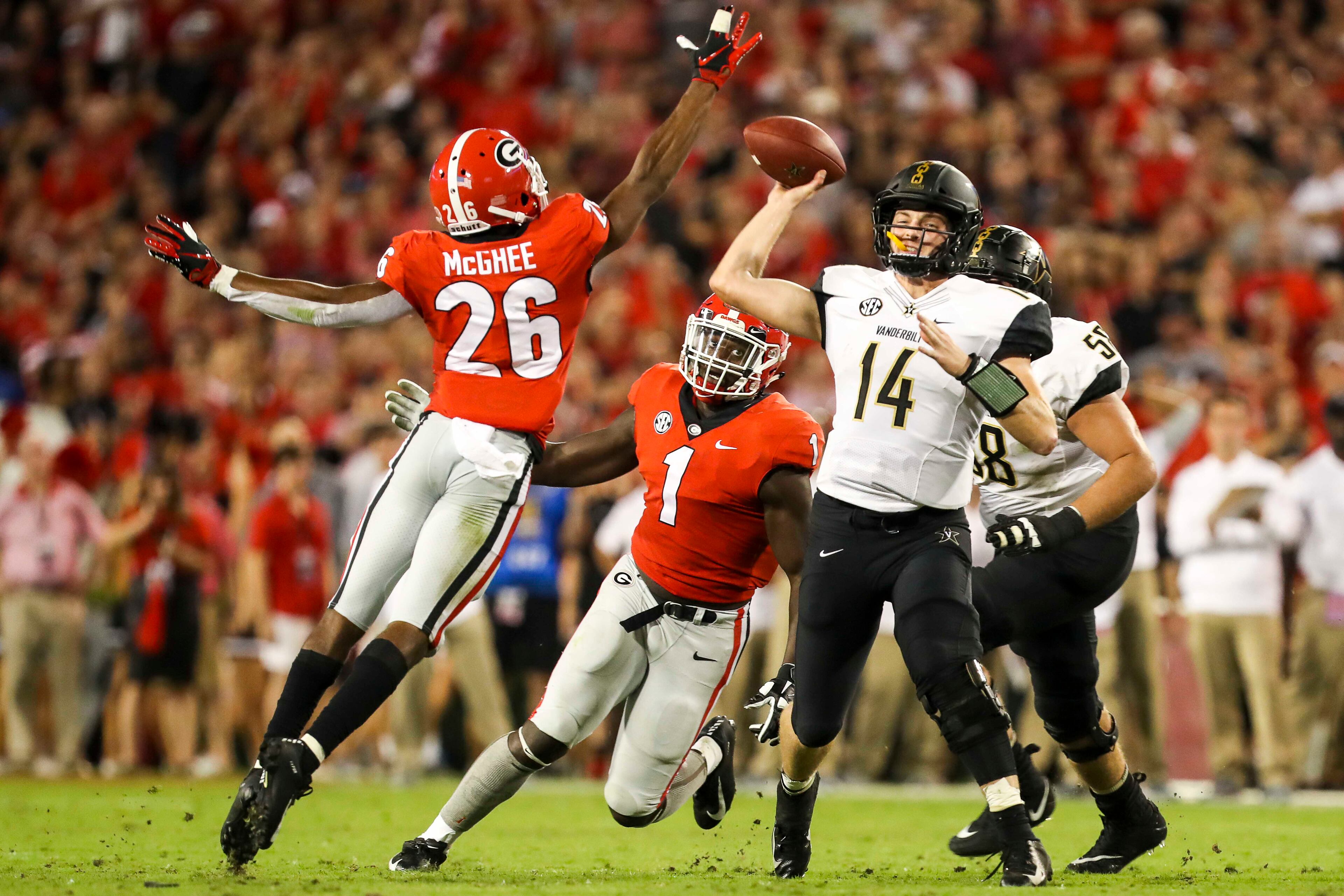 10/06/2018 -- Athens, Georgia -- Feeling pressure from Georgia defensive back Tyrique McGhee (26), Vanderbilt quarterback Kyle Shurmur (14) throws an incomplete pass during the second quarter of an NCAA college football game at Sanford Stadium in Athens, Saturday, October 6, 2018. (ALYSSA POINTER/ALYSSA.POINTER@AJC.COM)