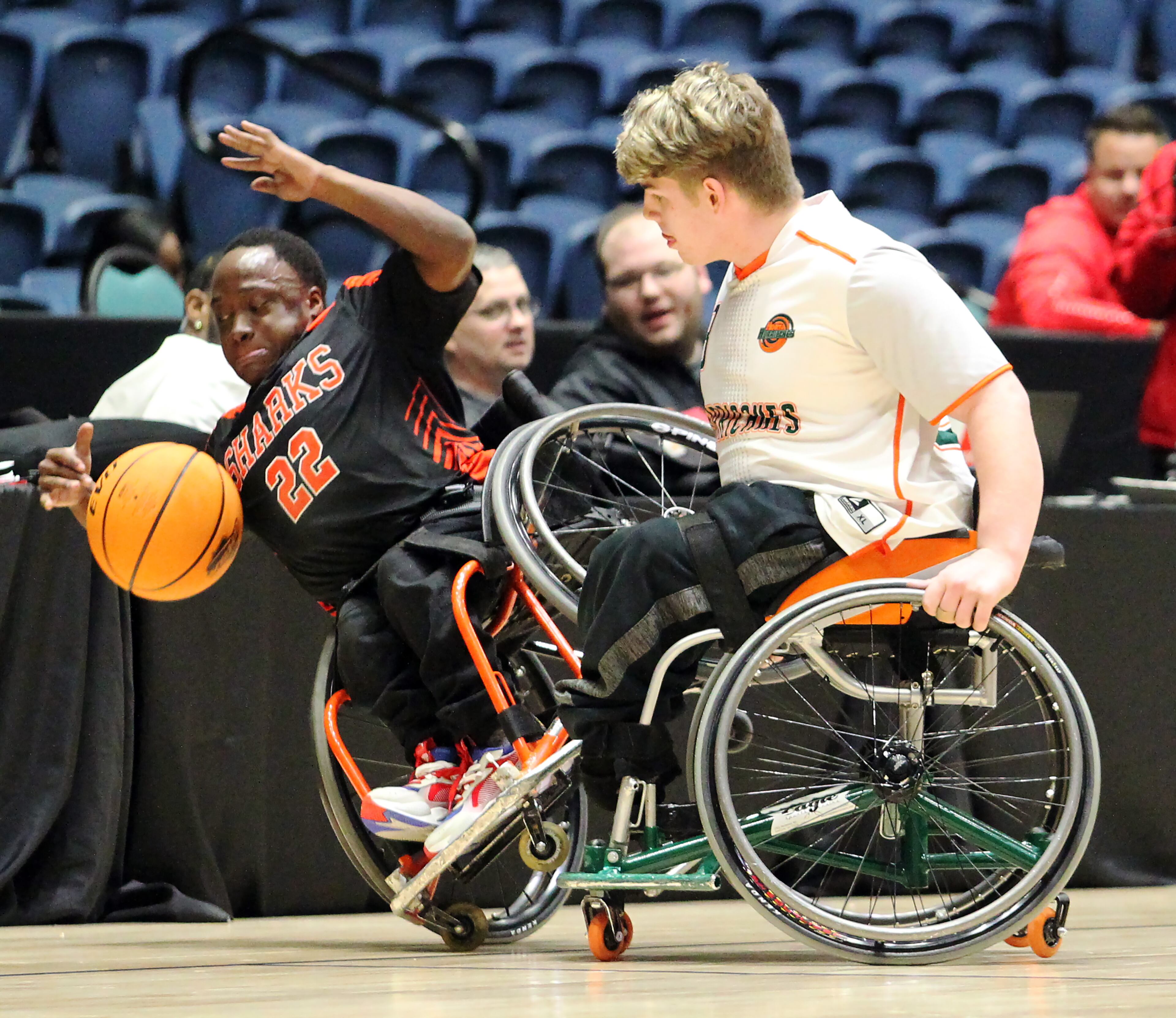 Houston Sharks' O'lando Hicks (left) is fouled by a Henry Hurricanes defender in the first half of the GHSA wheelchair state title game at the Macon Centreplex, Friday March 6, 2020, in Macon. Tami Chappell for the Atlanta Journal Constitution
