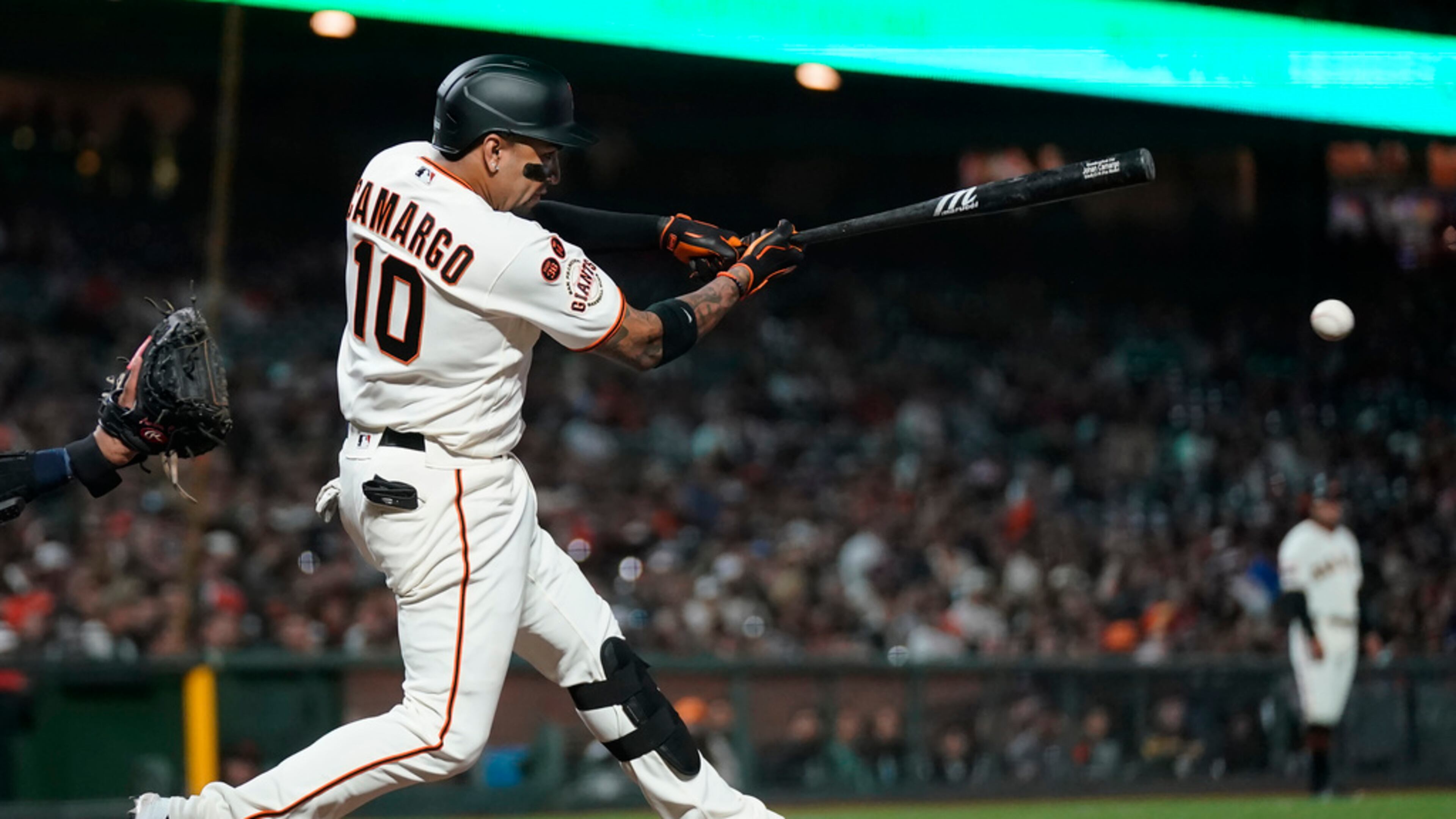 San Francisco Giants' Johan Camargo hits a single against the Tampa Bay Rays during the seventh inning of a baseball game in San Francisco, Monday, Aug. 14, 2023. (AP Photo/Jeff Chiu)