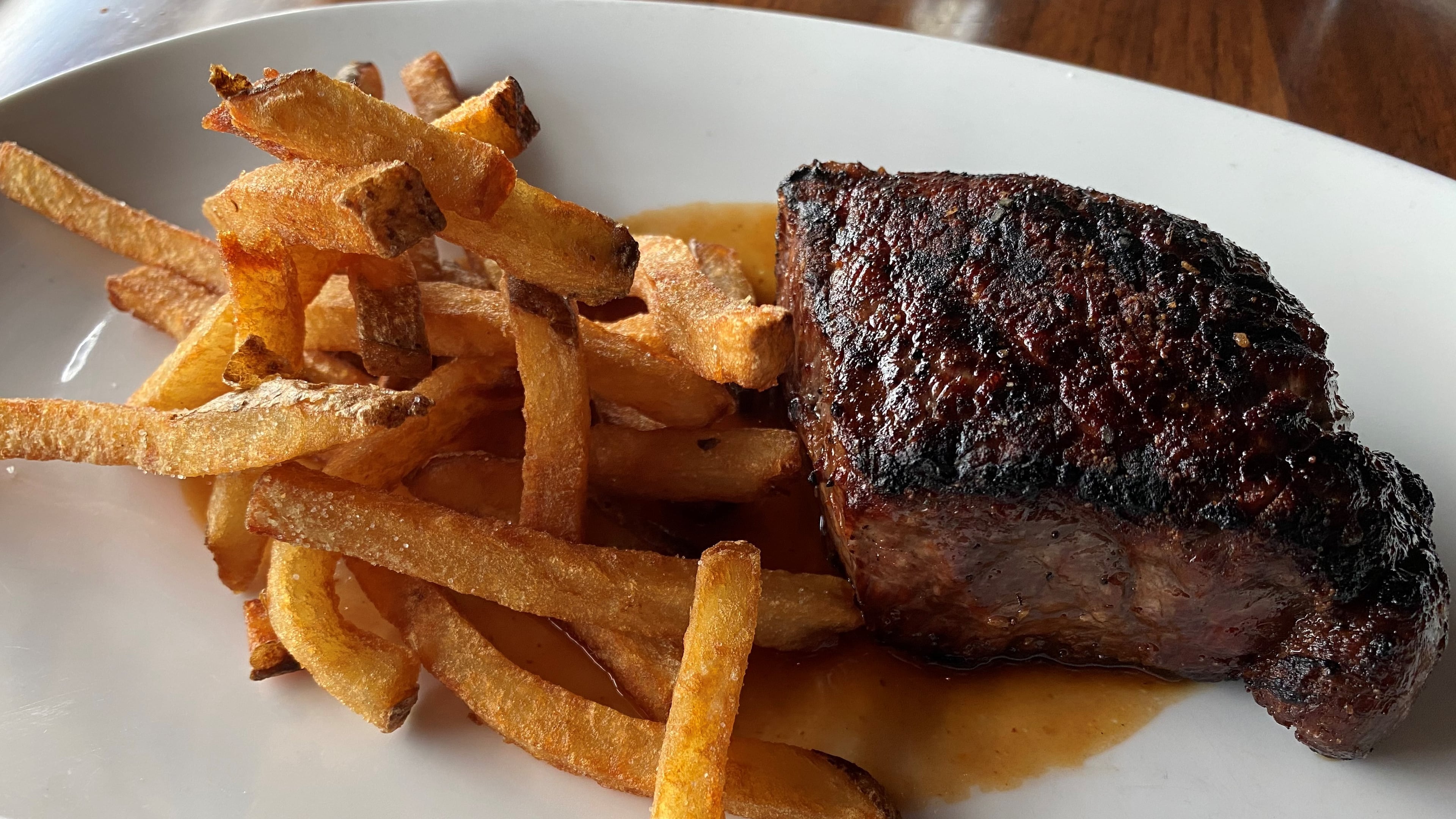Kaiser’s Chophouse in Sandy Springs offers an 8-ounce prime New York strip steak with hand-cut fries and garlic-pepper dust. Bob Townsend for The AJC