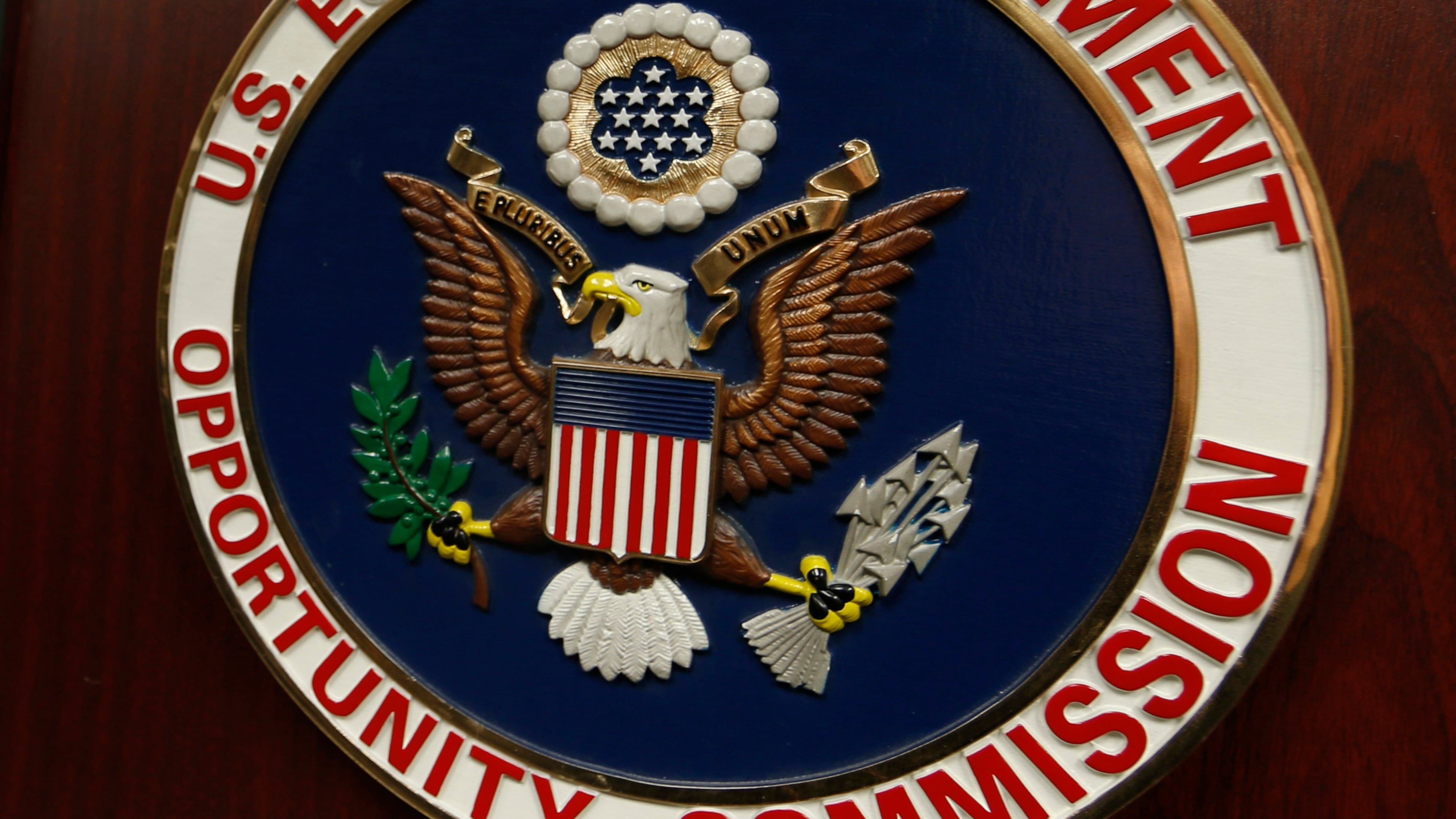 FILE - The emblem of the U.S. Equal Employment Opportunity Commission (EEOC) is displayed on a podium in Denver on Feb. 16, 2016. (AP Photo/David Zalubowski, File)